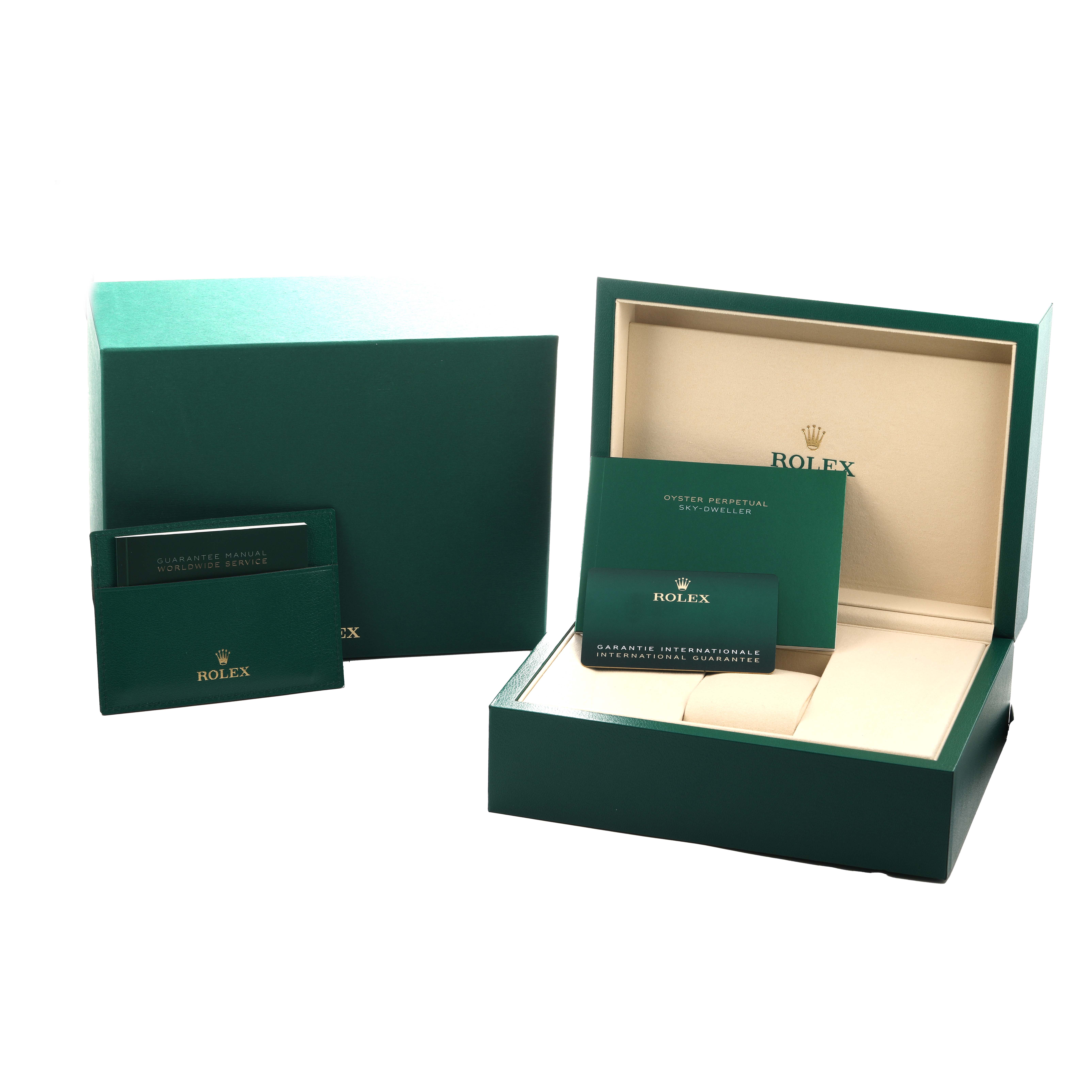 The image shows packaging and accessories for a Rolex GMT-Master 126711 Men
s Steel and Gold (two tone) Black Dial, including boxes and documentation from a front angle.