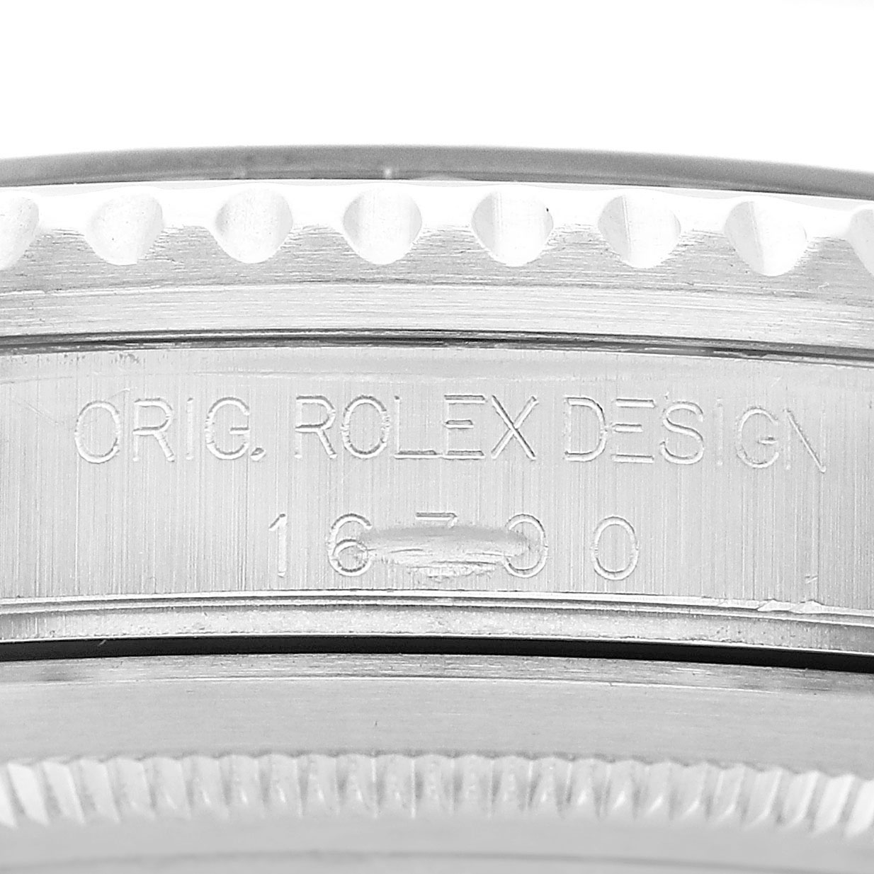 The image shows the side engraving on the bezel of a Rolex GMT-Master 16700 Men's Stainless Steel Black Dial, highlighting the model number.