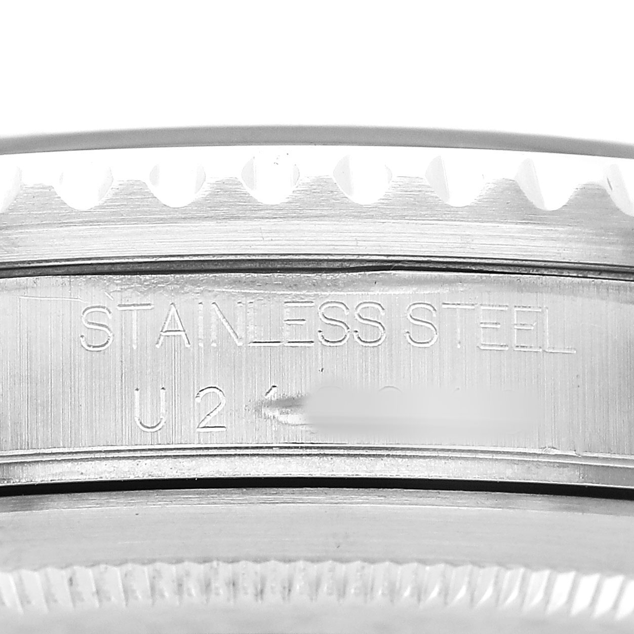 The image shows a close-up of the side of a Rolex GMT-Master 16700 Men's Stainless Steel Black Dial, highlighting its stainless steel case with engraving.