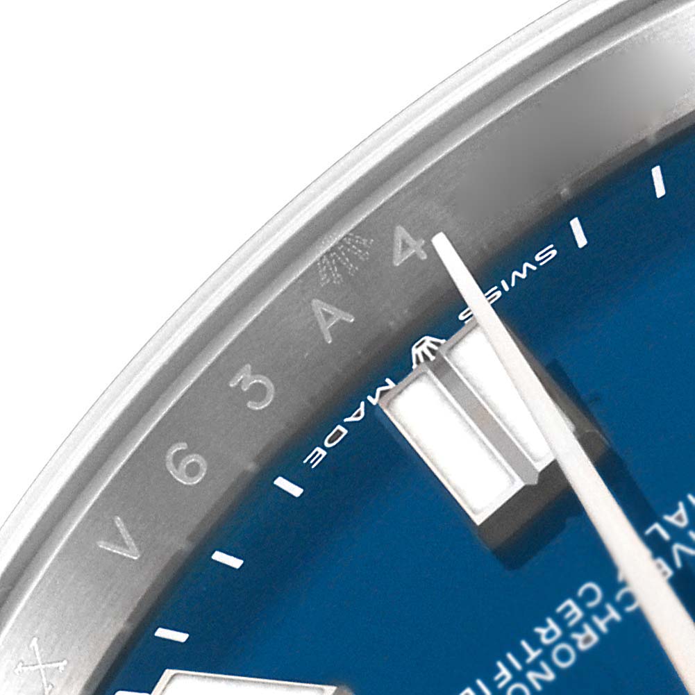 This image shows a close-up of the dial and indices of a Rolex Oyster Perpetual 124300 Men
s Stainless Steel Blue Dial 124300 Men
s Stainless Steel Blue Dial watch, particularly focusing on the 4 and 5 o
clock positions.