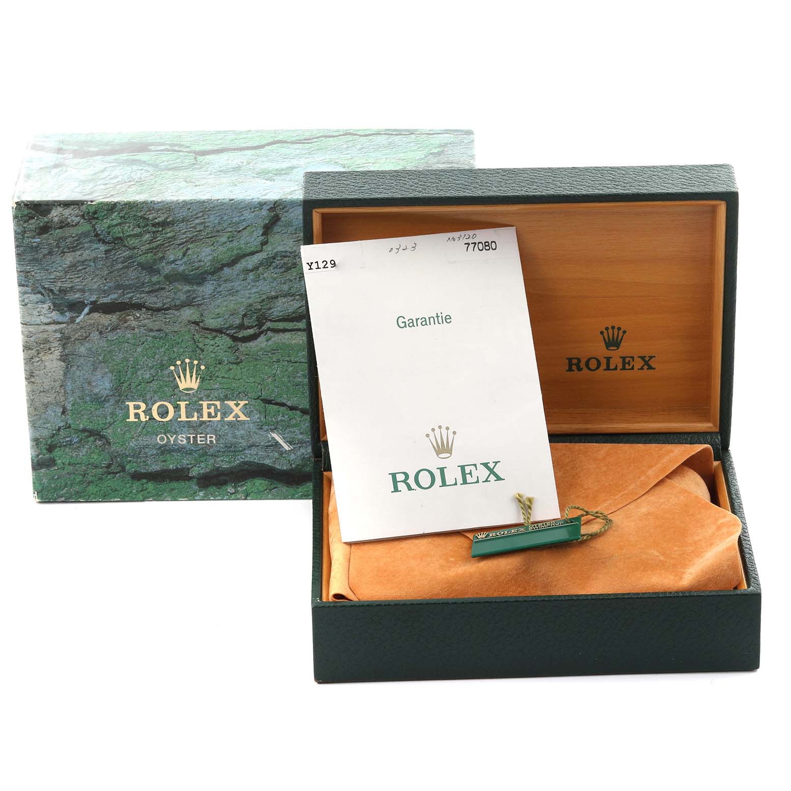 The image shows a Rolex box and warranty card, with a partially visible watch cushion inside.