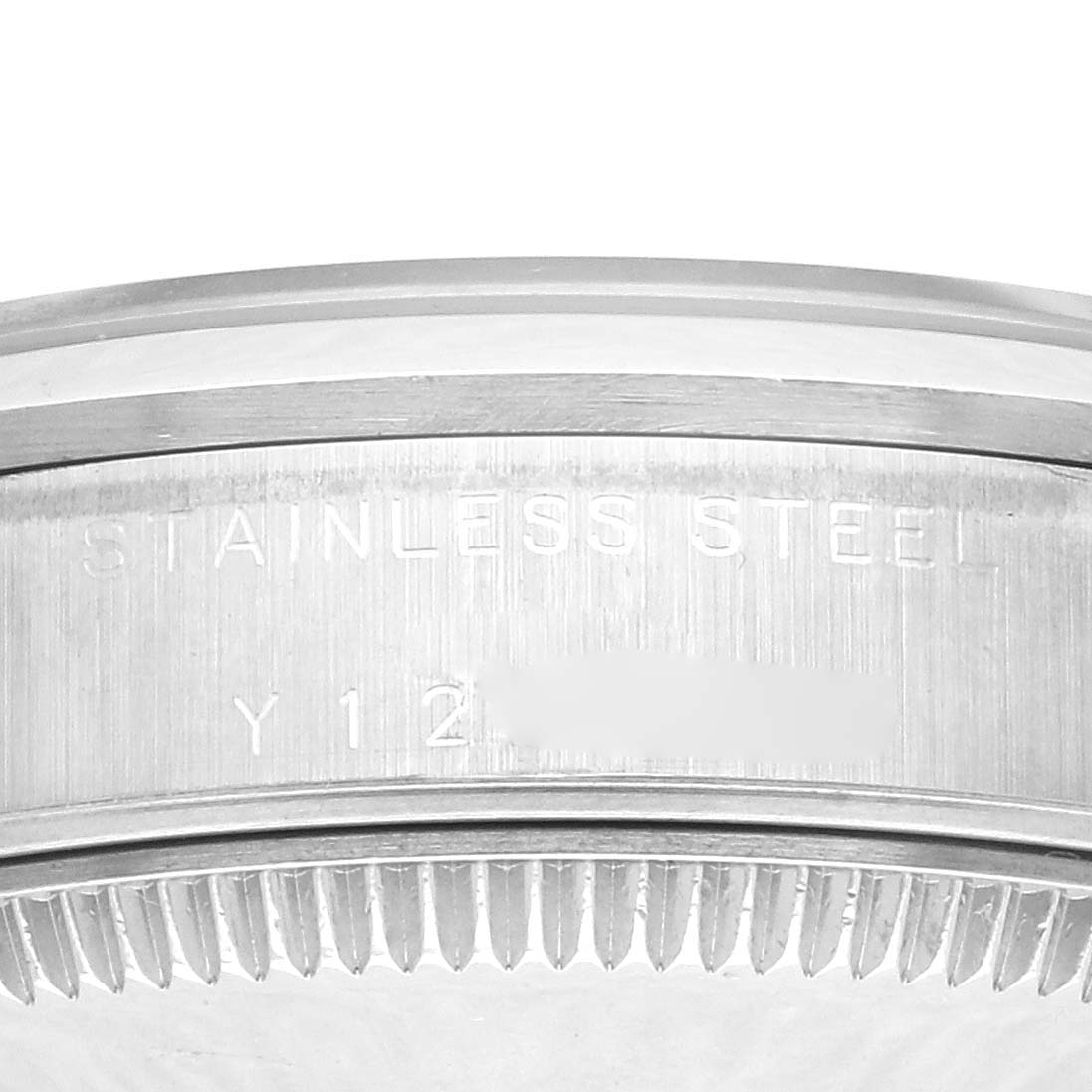 The image shows a close-up of the Rolex Mid-Size 77080 Women's Stainless Steel Black Dial 77080 Women's Stainless Steel Black Dial watch's stainless steel case back with engraved markings.