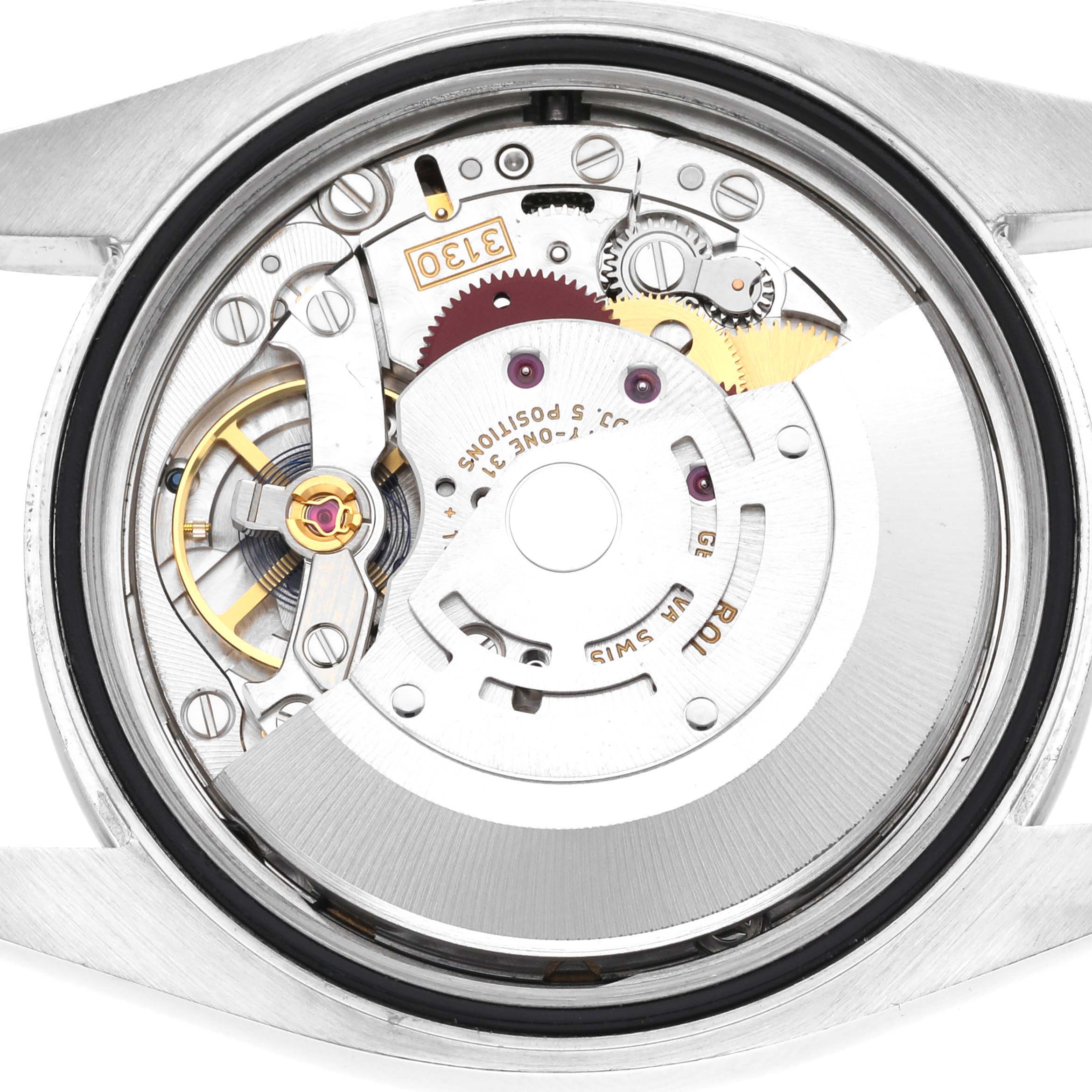 The image shows the movement mechanism of a Rolex Oyster Perpetual 116000 Men's Stainless Steel Purple Dial watch from the back.
