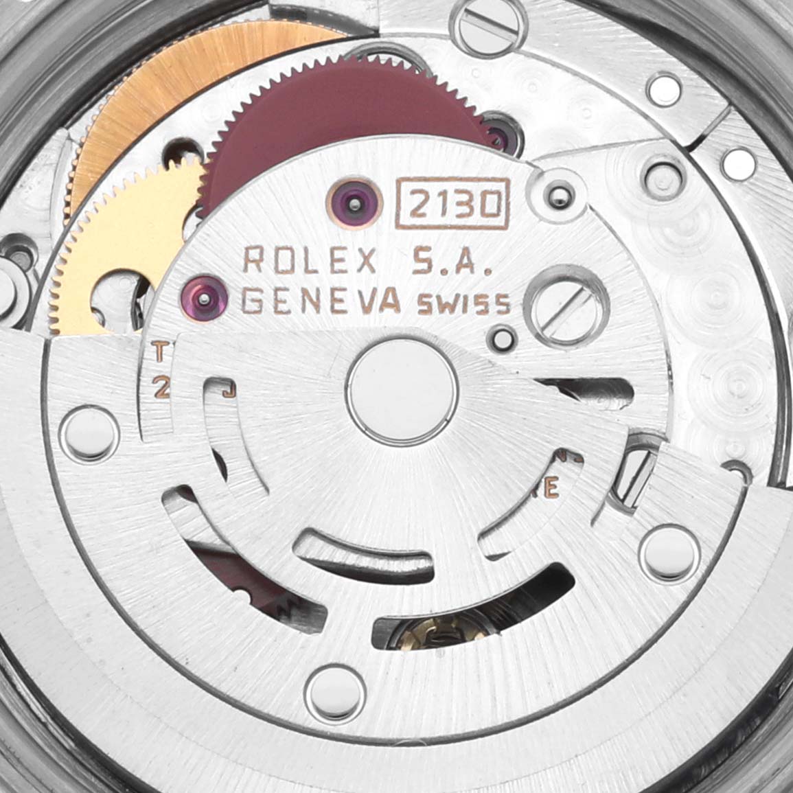 The image shows the internal mechanism of the Rolex Oyster Perpetual 67193 Women's Steel and Gold (two tone) Champagne Dial 67193 Women's Steel and Gold (two tone) Champagne Dial watch, highlighting gears and inscriptions on the movement.