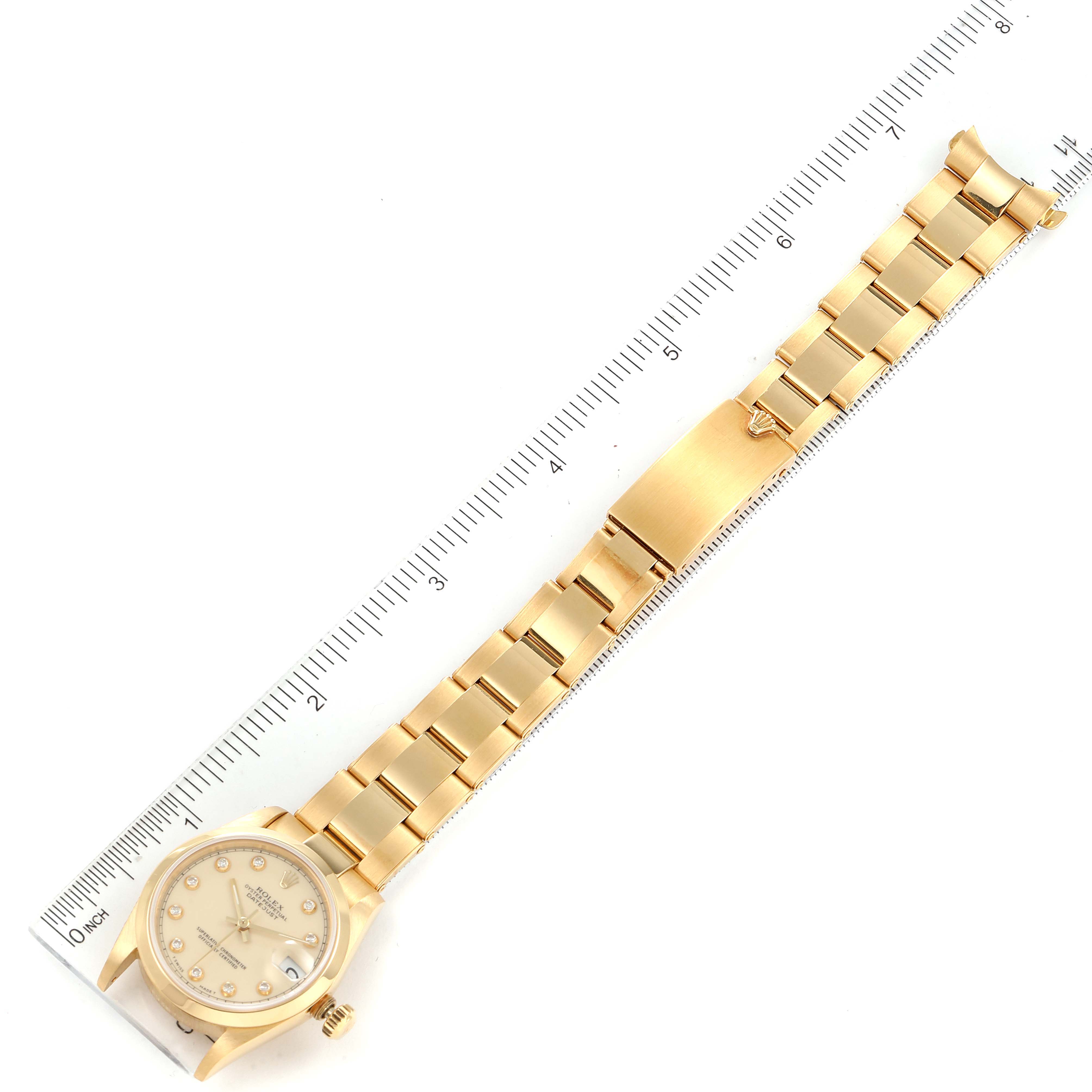 The image shows a Rolex President 68248 Women
s Yellow Gold Beige Dial 68248 Women
s Yellow Gold Beige Dial watch laid flat with a ruler beside it, displaying the watch face and entire bracelet.