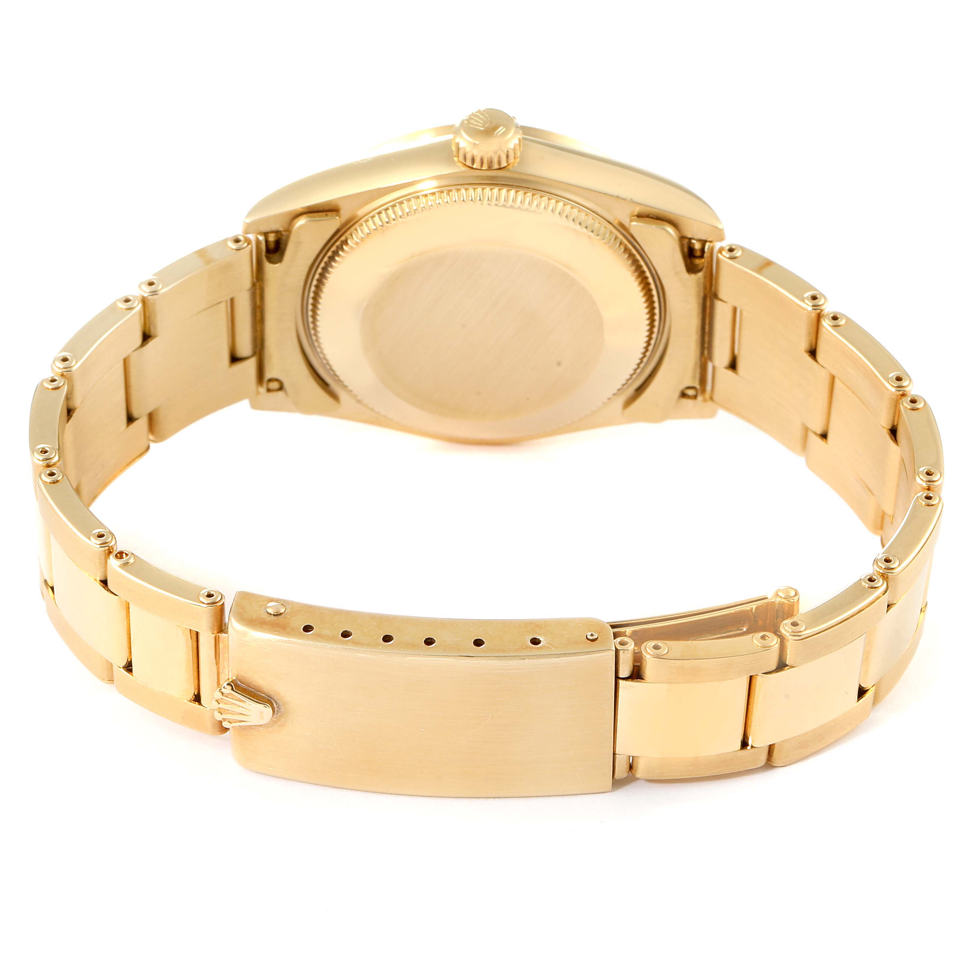 This image shows the back and clasp of a Rolex President 68248 Women
s Yellow Gold Beige Dial 68248 Women
s Yellow Gold Beige Dial model watch, highlighting its metal bracelet and case back.