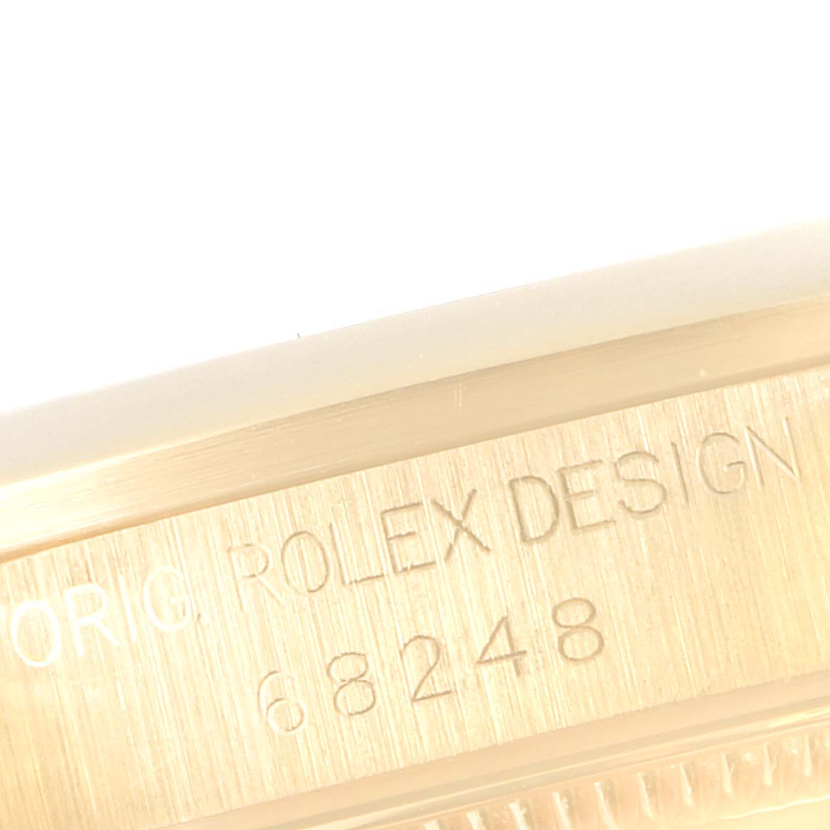 The image shows a close-up of the side engraving of a Rolex President 68248 Women
s Yellow Gold Beige Dial 68248 Women
s Yellow Gold Beige Dial model watch, displaying model number 68248.