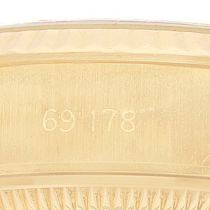 The image shows a close-up of the side of a Rolex President 69178 Women
s Yellow Gold Champagne Dial 69178 Women
s Yellow Gold Champagne Dial
s gold case, featuring the reference number 69178.