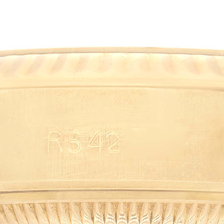 The image shows a close-up of the fluted bezel of a Rolex President 69178 Women
s Yellow Gold Champagne Dial 69178 Women
s Yellow Gold Champagne Dial model watch.