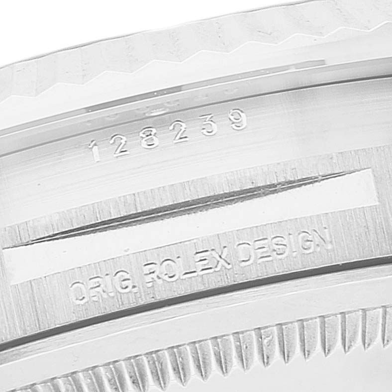 This close-up image shows the case number "128239" and "ORIG. ROLEX DESIGN" engraving on the Rolex President 128239 Men's White Gold Pink Dial 128239 Men's White Gold Pink Dial model watch.