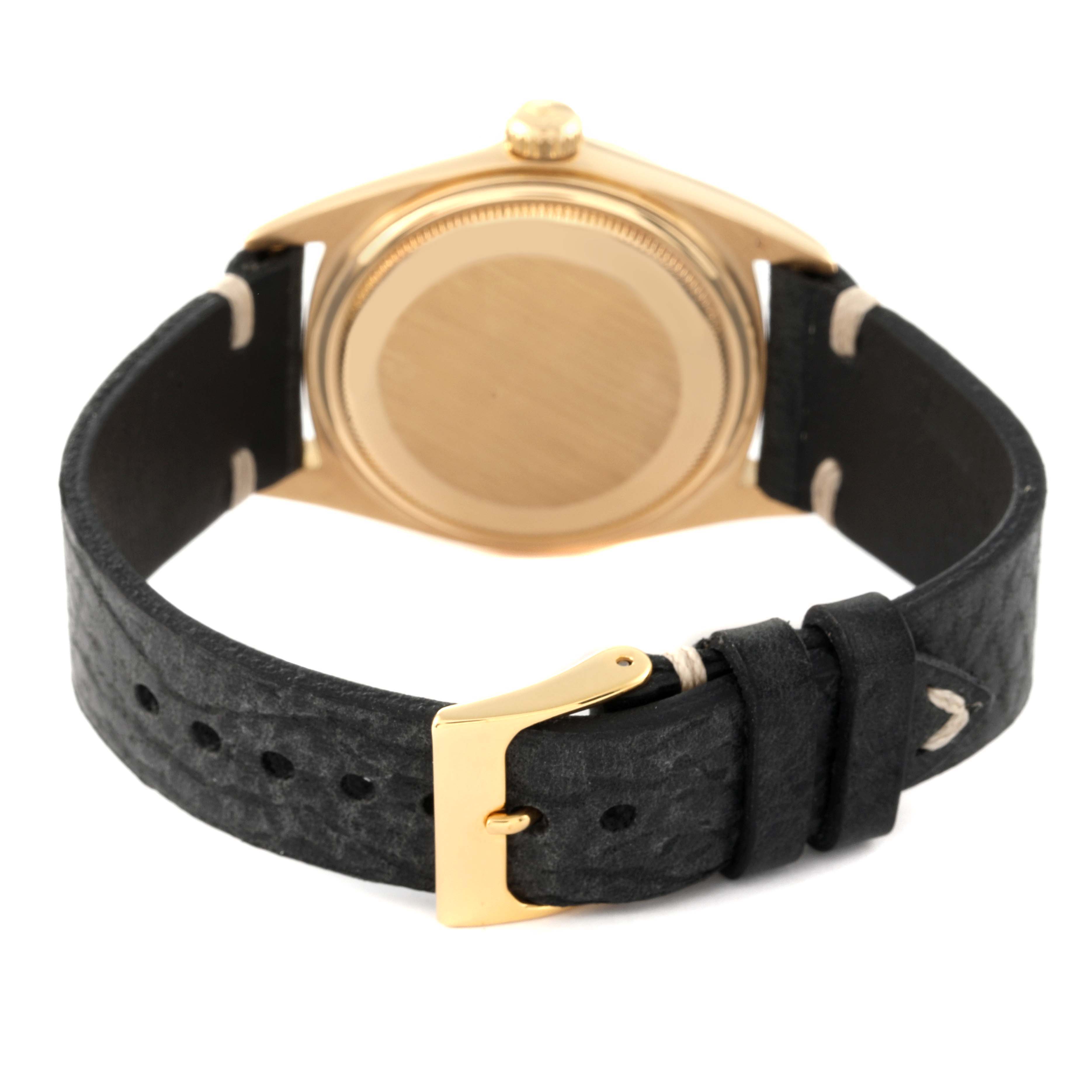 The image shows the back view of a Rolex Vintage Collection 1807 Men's Yellow Gold Champagne Dial 1807 Men's Yellow Gold Champagne Dial watch, highlighting its case back, crown, and leather strap with a buckle.