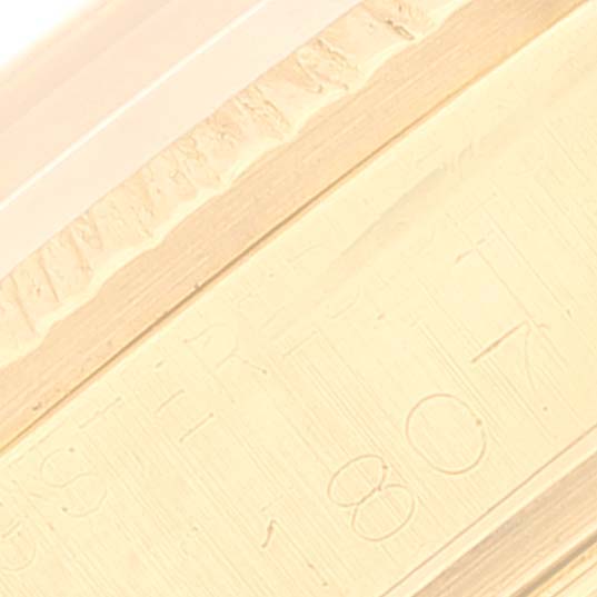 The image shows a close-up of the side engraving on the bezel of a Rolex Vintage Collection 1807 Men's Yellow Gold Champagne Dial 1807 Men's Yellow Gold Champagne Dial watch.