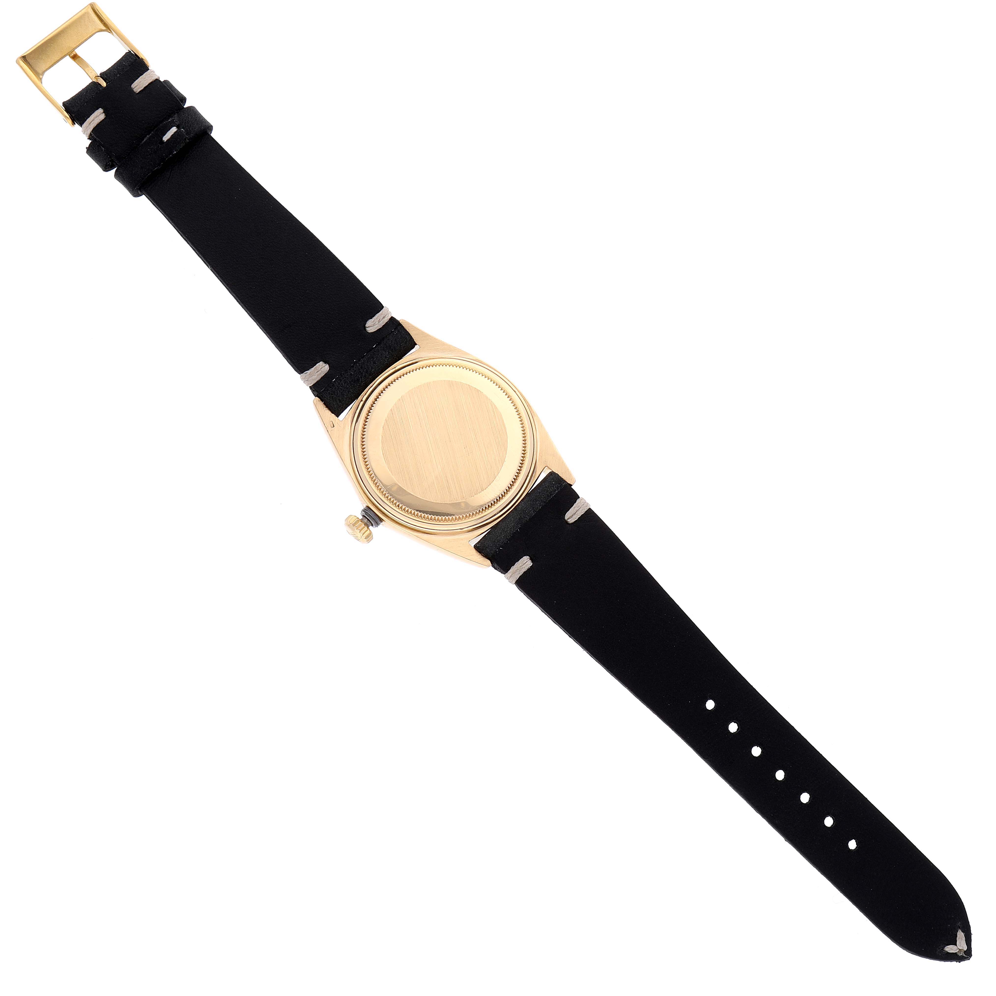 This image shows the back view of a Rolex Vintage Collection 1807 Men's Yellow Gold Champagne Dial 1807 Men's Yellow Gold Champagne Dial watch with a black leather strap and gold case.