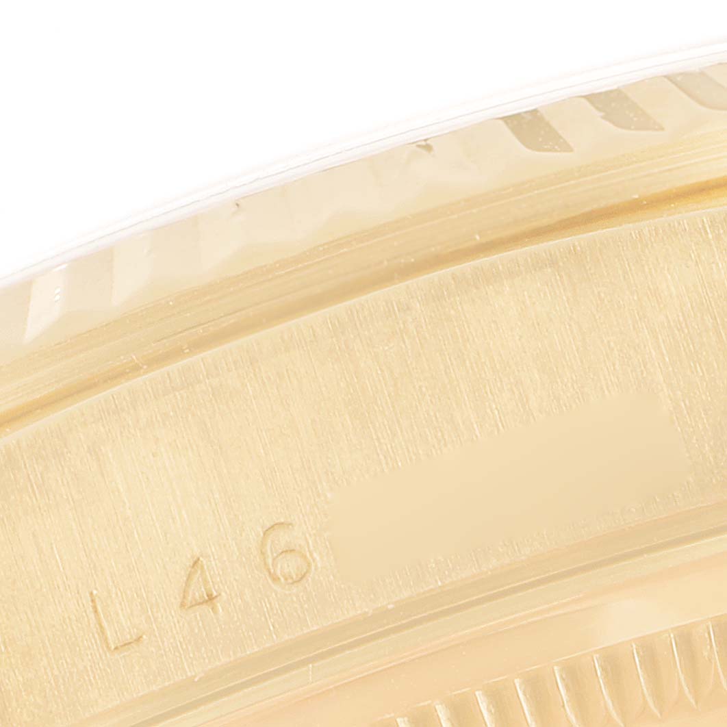 This image shows a close-up of the edge and serial number engraving on a Rolex President 18238 Men's Yellow Gold Champagne Dial 18238 Men's Yellow Gold Champagne Dial model watch.