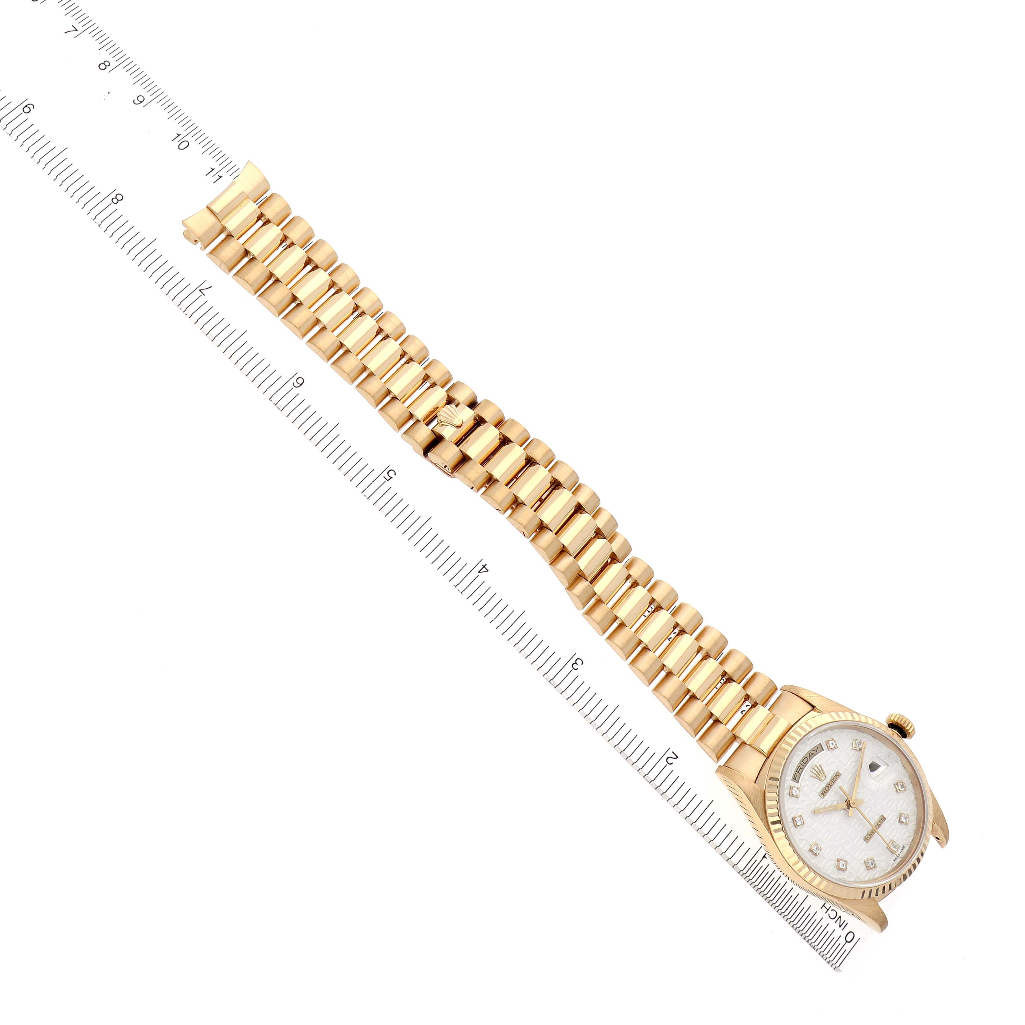 The Rolex President 18238 Men's Yellow Gold Silver Dial 18238 Men's Yellow Gold Silver Dial watch is shown from a top-down angle, displaying the bracelet, bezel, dial, and part of a ruler.