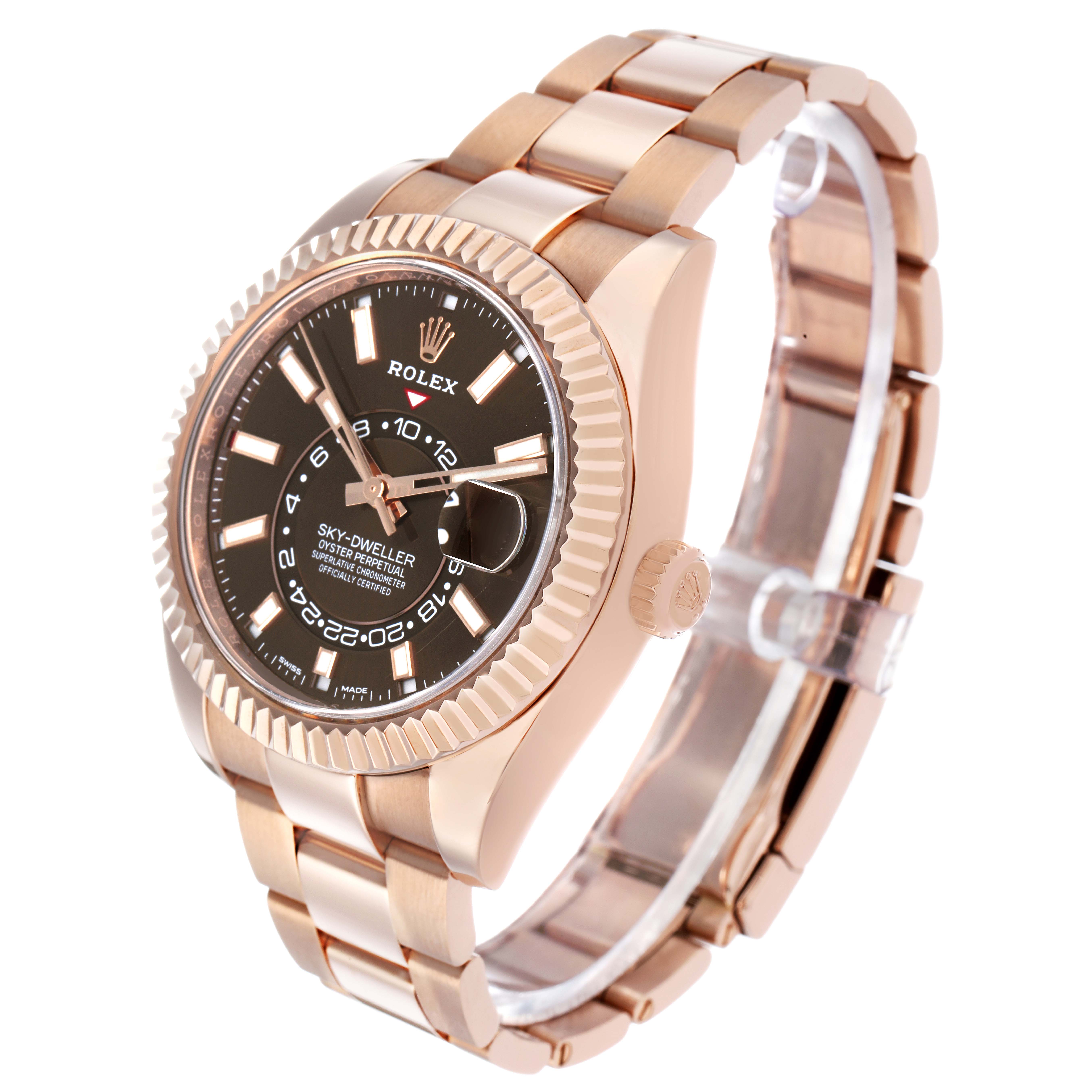 The Rolex Sky-Dweller 326935 Men's Rose Gold Brown Dial watch is shown at a three-quarter angle, highlighting the dial, bezel, and bracelet.