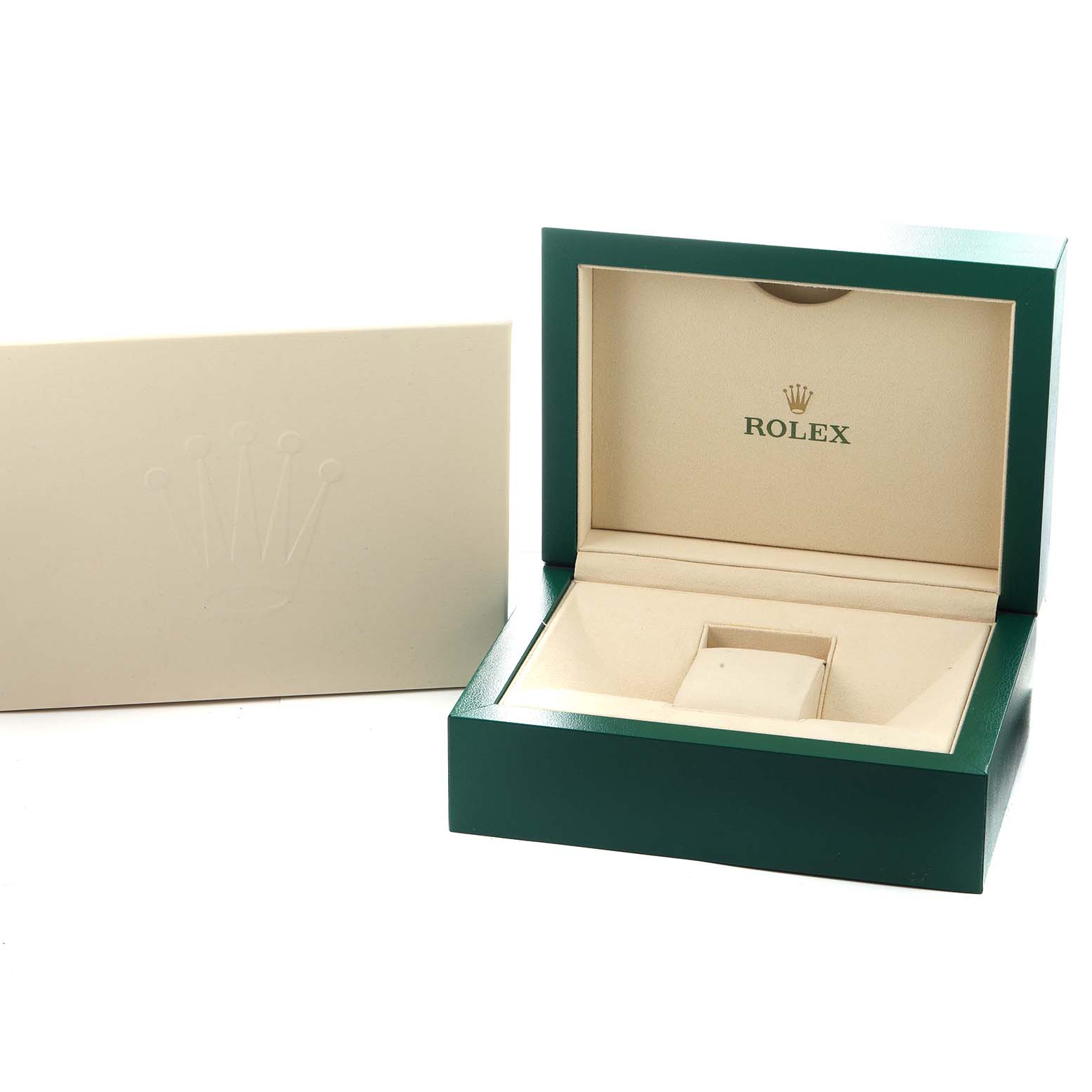 The image shows an open green Rolex box for the Sky-Dweller model, revealing its interior packaging and a separate cream-colored card or booklet.