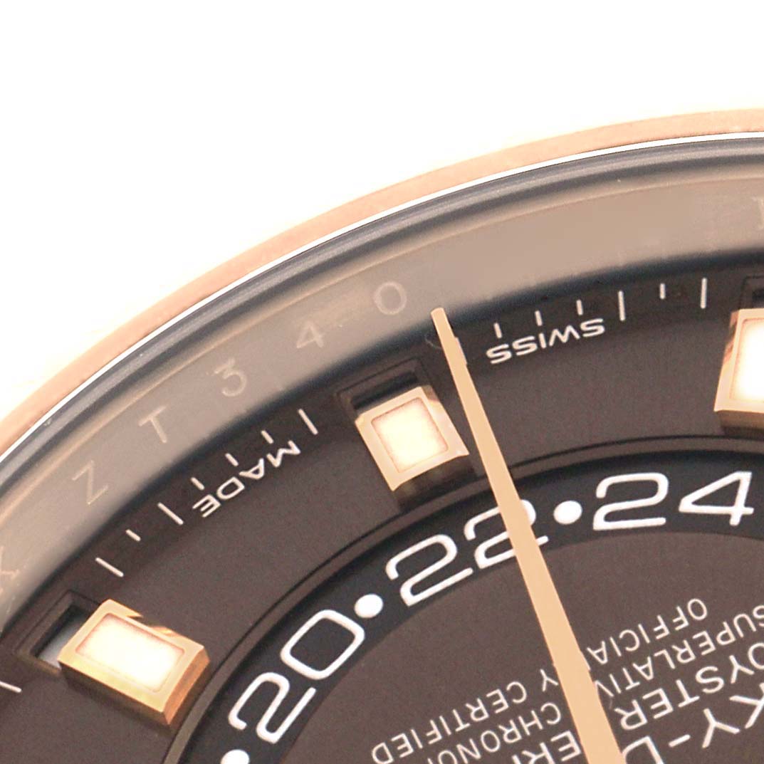 The image shows a close-up of the Rolex Sky-Dweller 326935 Men's Rose Gold Brown Dial's dial, highlighting the hour markers and part of the minute hand.
