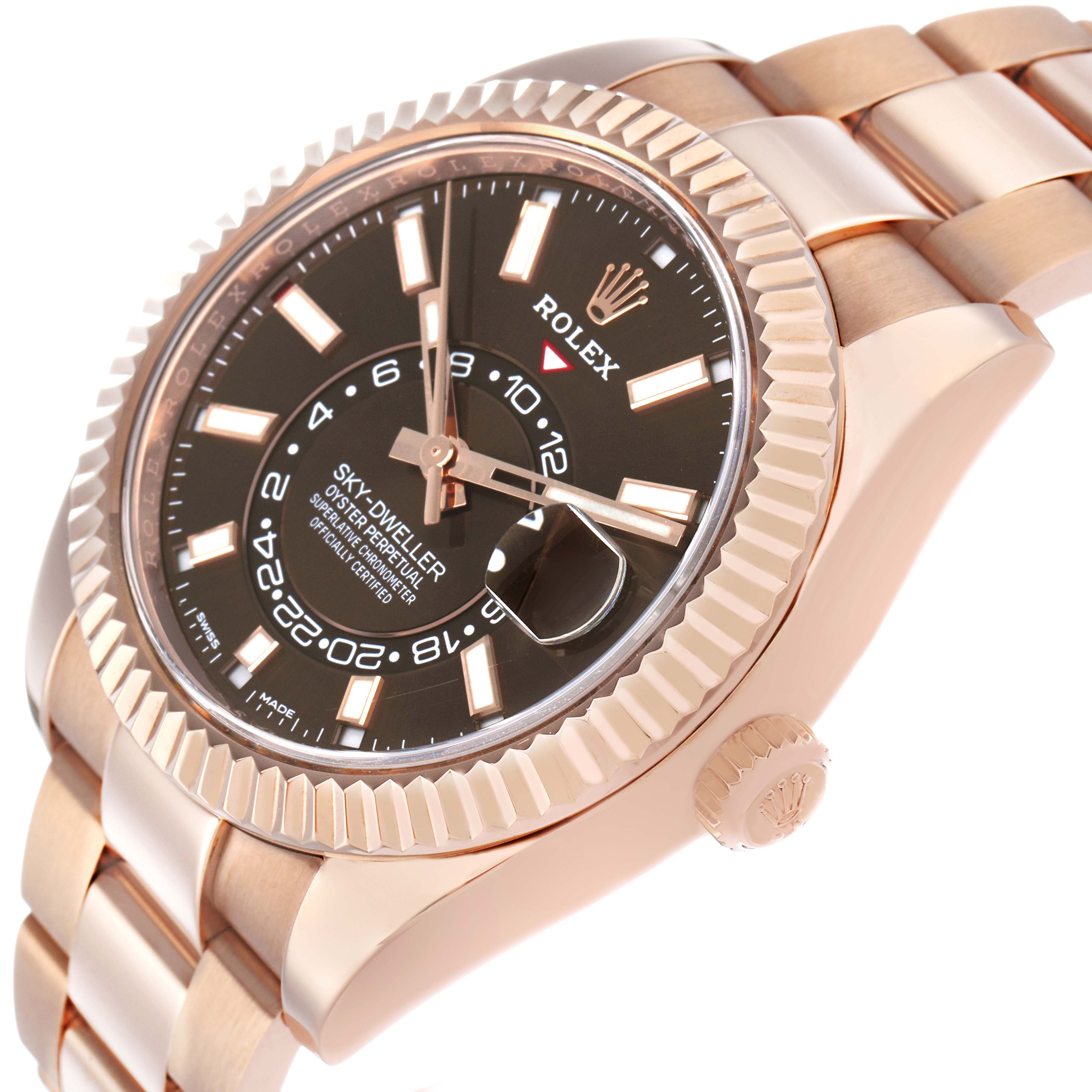 The Rolex Sky-Dweller 326935 Men's Rose Gold Brown Dial watch is shown at an angled view, highlighting the dial, fluted bezel, and bracelet.