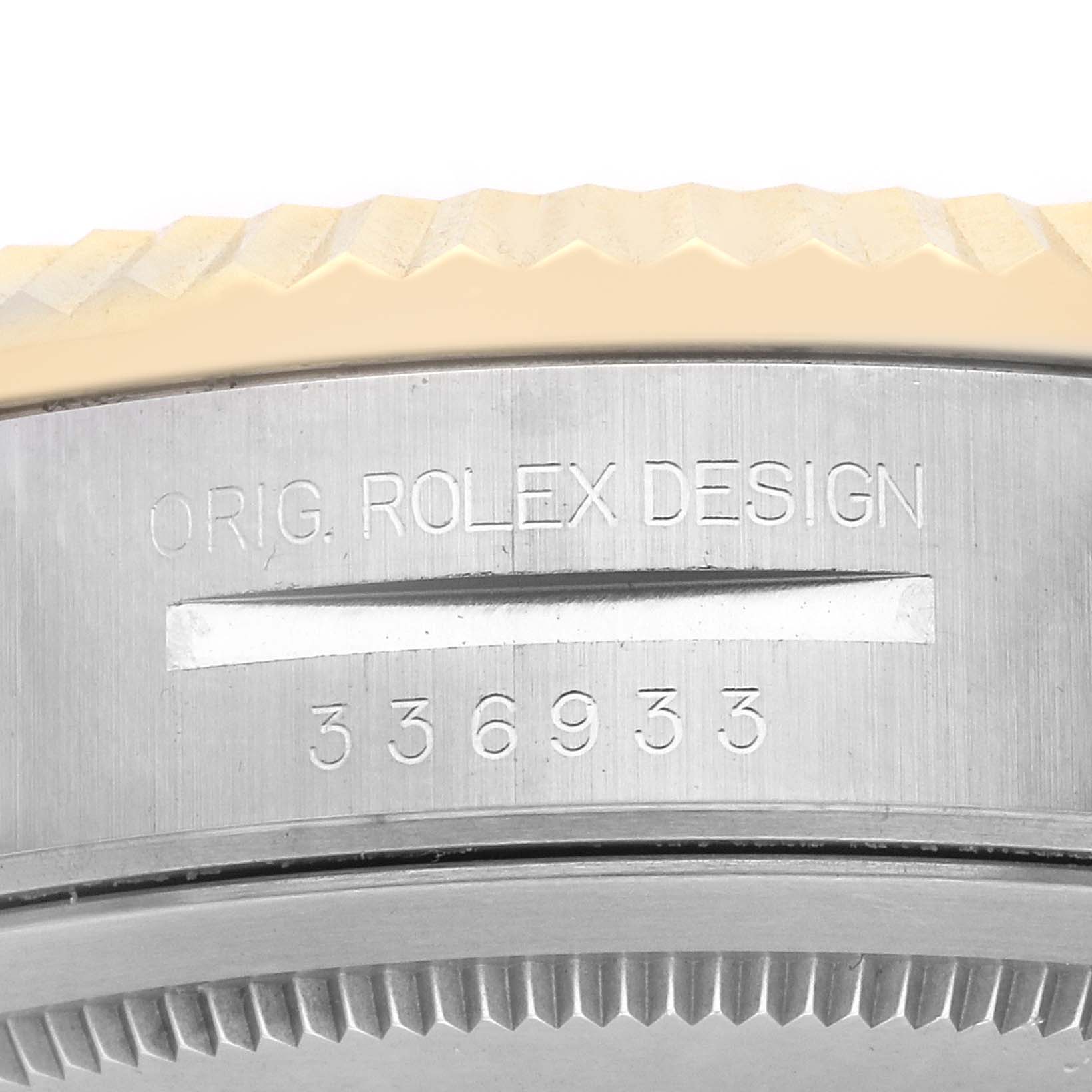 The image shows a close-up of the side of a Rolex Sky-Dweller 336933 Men
s Steel and Gold (two tone) Silver Dial, highlighting the engraved serial number and "ORIG. ROLEX DESIGN."