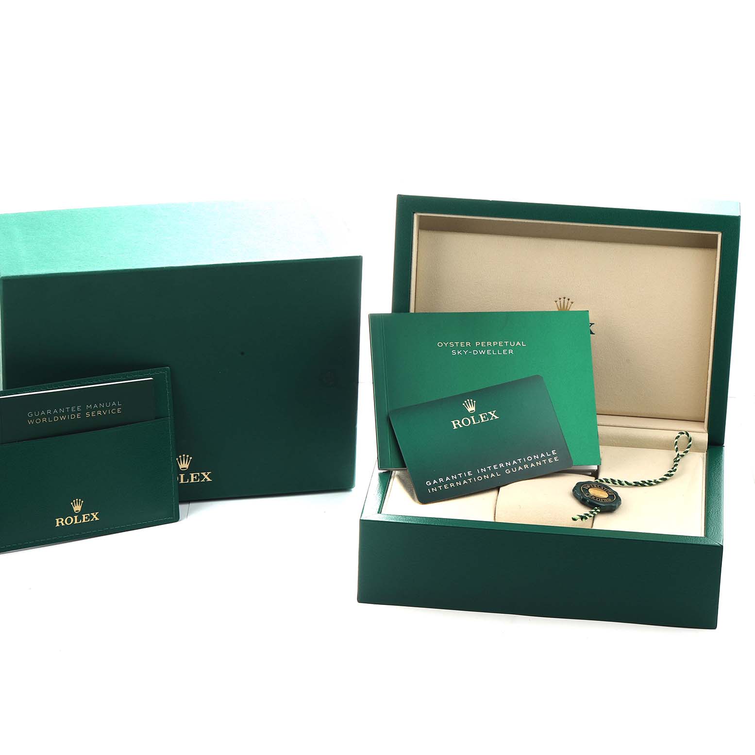 The image shows the packaging and documentation for a Rolex Sky-Dweller 336933 Men
s Steel and Gold (two tone) Silver Dial, including the box, manuals, and warranty card.