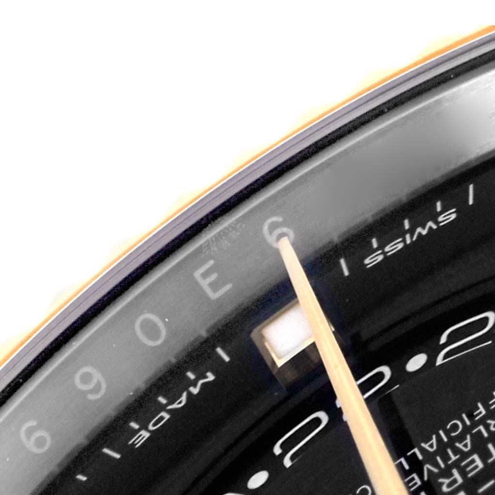 This is a close-up of the dial and bezel of a Rolex Sky-Dweller 326933 Men's Steel and Gold (two tone) Black Dial 326933 Men's Steel and Gold (two tone) Black Dial, showcasing part of the chapter ring and hour markers.
