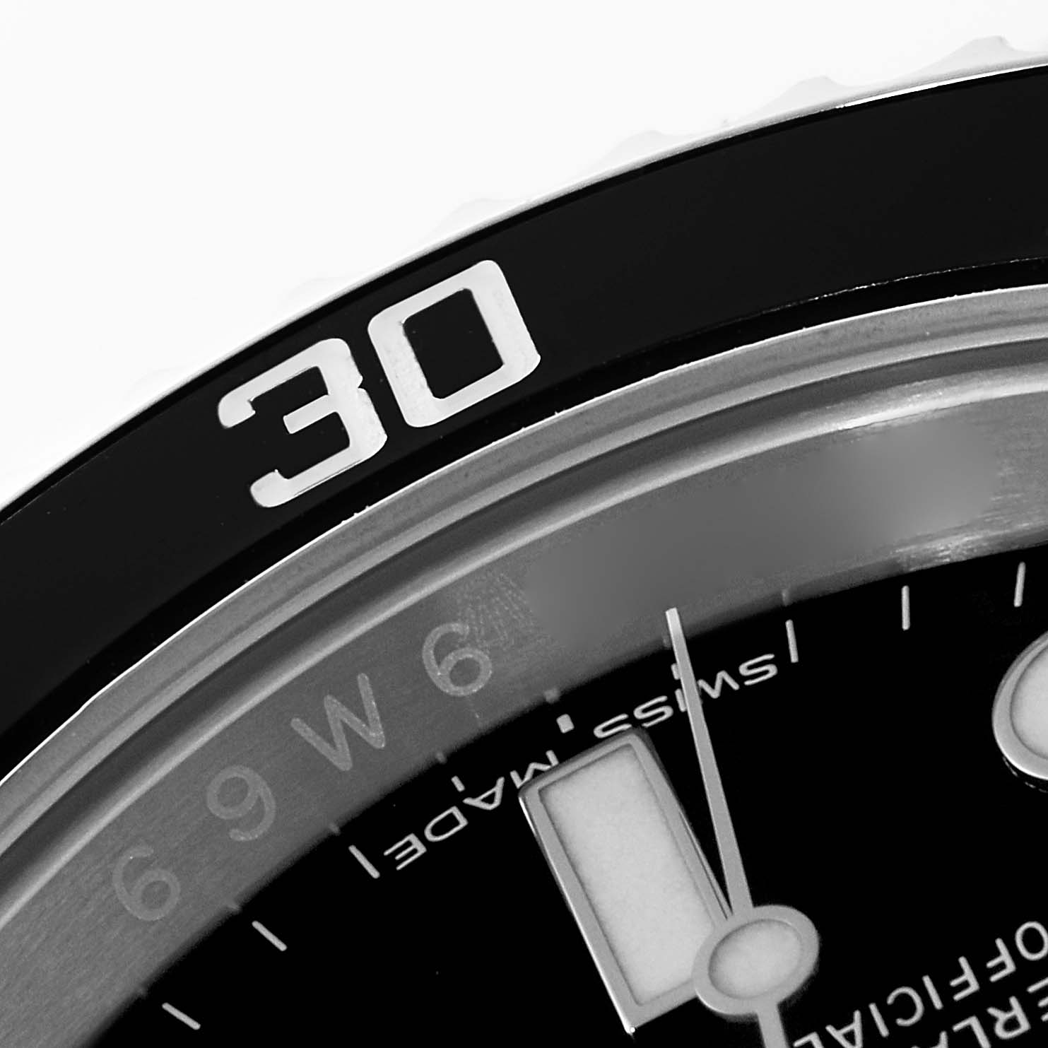 The image shows a close-up of the bezel and part of the dial of a Rolex Submariner 116610 Men
s Stainless Steel Black Dial 116610 Men
s Stainless Steel Black Dial watch, focusing on the 30-minute mark.