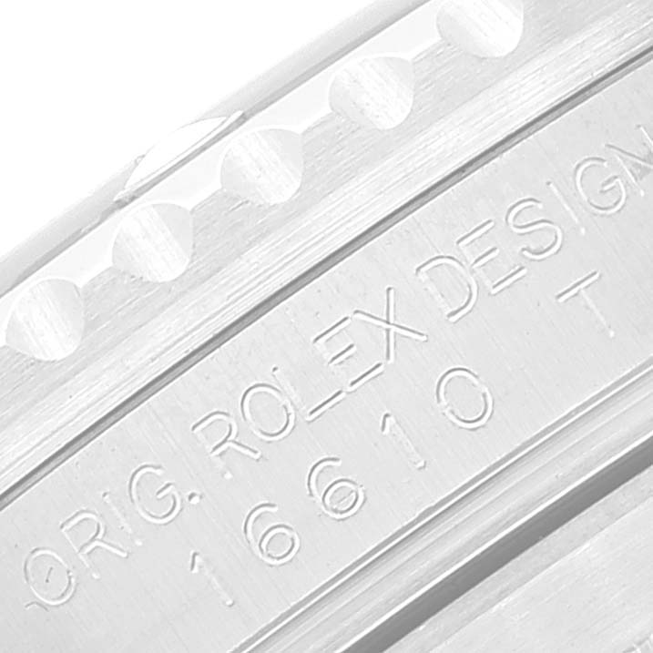 This close-up image shows the engraved serial number and "ORIG. ROLEX DESIGN" text on the side of the bezel of a Rolex Submariner 16610 Men
s Stainless Steel Black Dial 16610 Men
s Stainless Steel Black Dial.