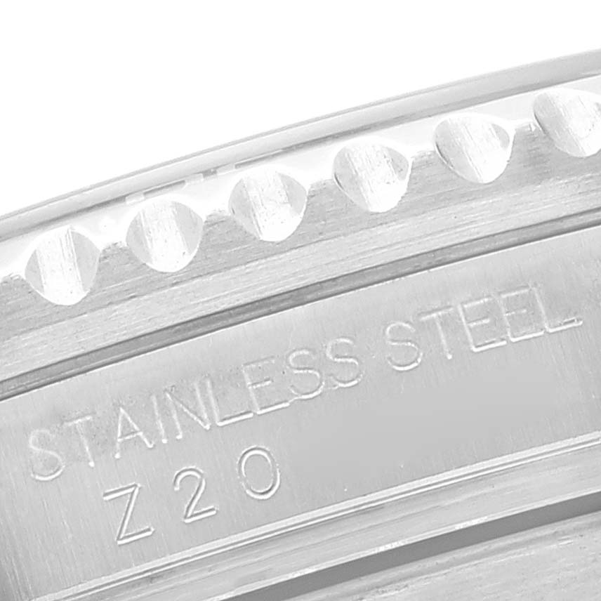 The image shows a close-up of the side of a stainless steel bezel on a Rolex Submariner 16610 Men's Stainless Steel Black Dial 16610 Men's Stainless Steel Black Dial watch.