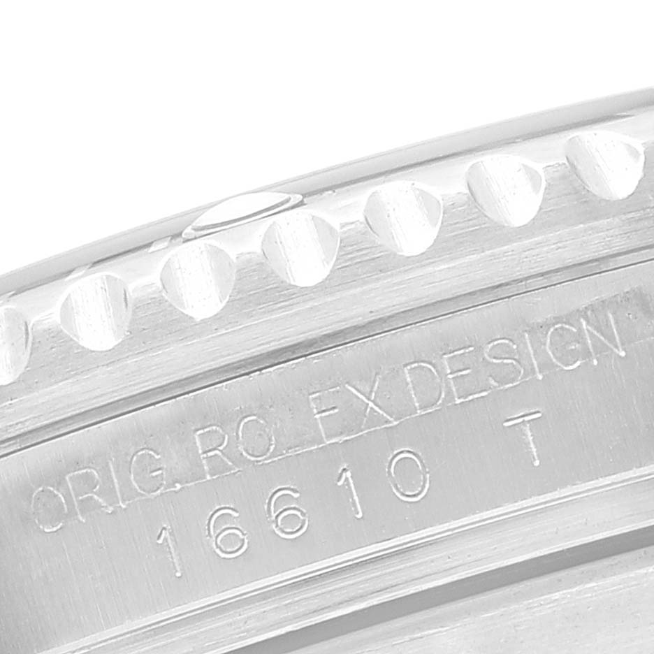 This image shows a close-up of the case and part of the bezel of a Rolex Submariner 16610 Men's Stainless Steel Black Dial 16610 Men's Stainless Steel Black Dial watch, revealing its model number 16610 T.