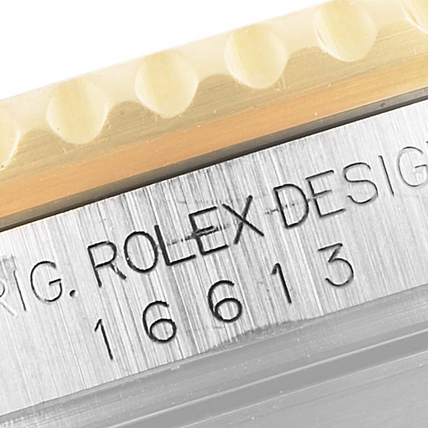 This image shows a close-up of the case side with the model number "16613" and the bezel edge of a Rolex Submariner 16613 Men
s Steel and Gold (two tone) Blue Dial 16613 Men
s Steel and Gold (two tone) Blue Dial.