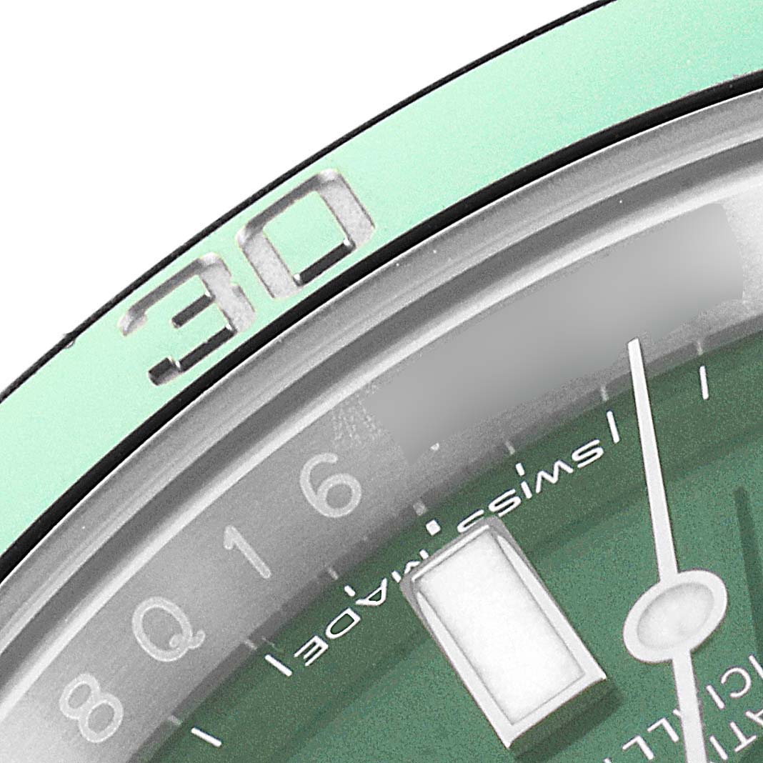 The image shows a close-up of the bezel and dial of a Rolex Submariner 116610LV Men
s Stainless Steel Green Dial 116610LV Men
s Stainless Steel Green Dial watch, focusing on the 30-minute marker and a portion of the watch face.