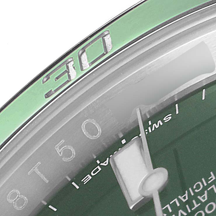 This close-up image shows the 30-minute mark on the green bezel and part of the dial of a Rolex Submariner 116610LV Men
s Stainless Steel Green Dial 116610LV Men
s Stainless Steel Green Dial watch.