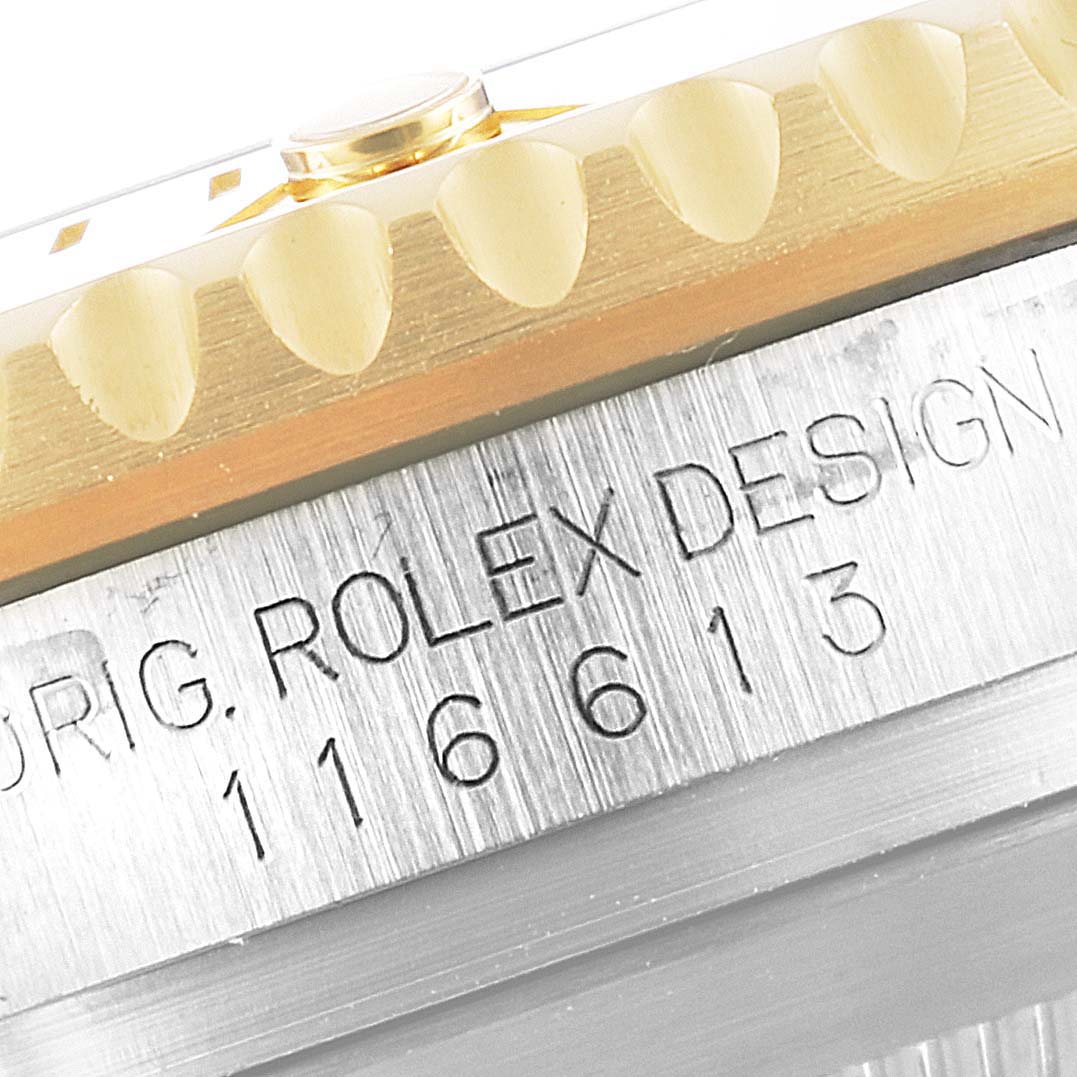 The image shows the edge of the bezel and the model number "116613" engraved on the side case of the Rolex Submariner 116613 Men's Steel and Gold (two tone) Blue Dial 116613 Men's Steel and Gold (two tone) Blue Dial.