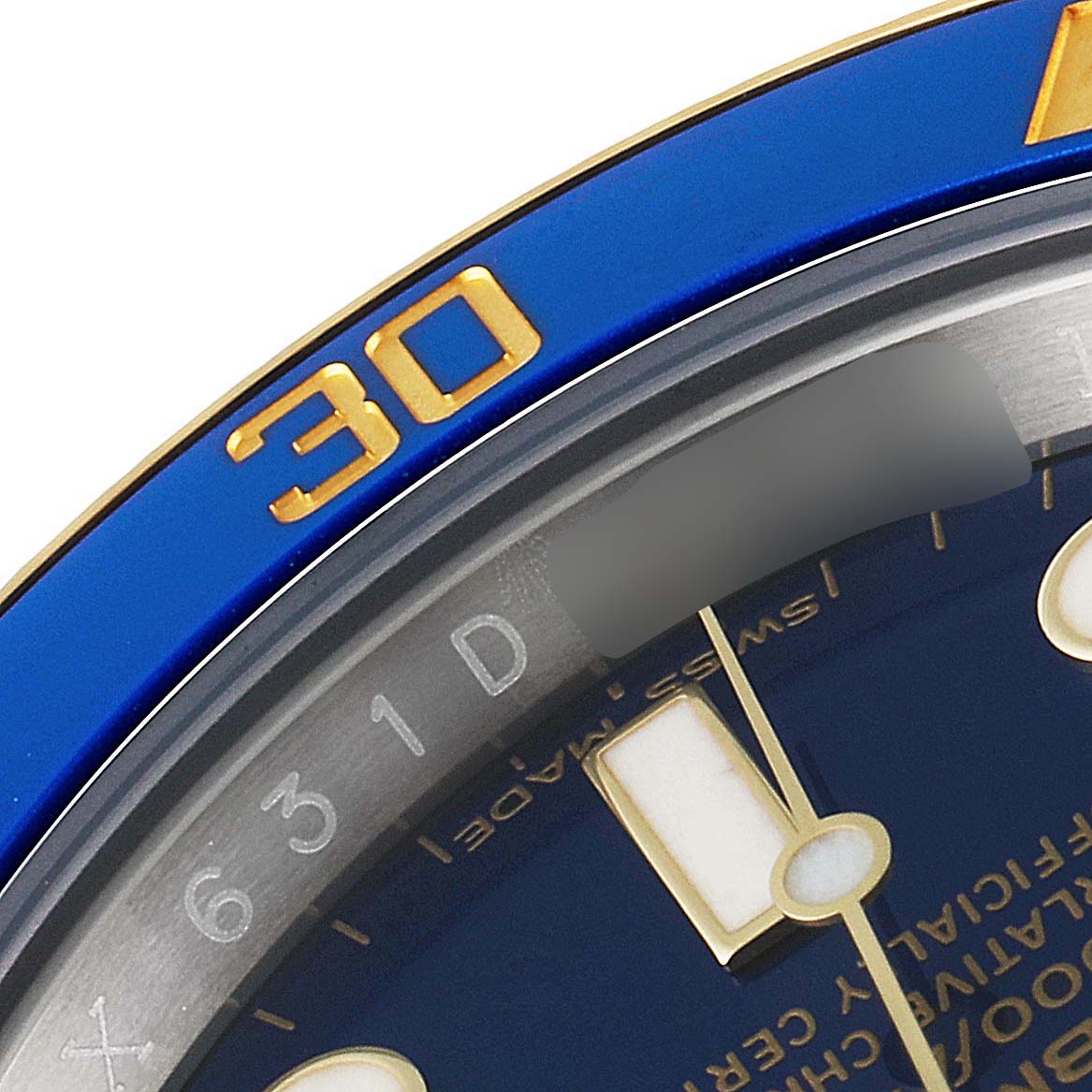 This image features a close-up of the bezel and a portion of the dial from a Rolex Submariner 116613 Men's Steel and Gold (two tone) Blue Dial 116613 Men's Steel and Gold (two tone) Blue Dial watch.