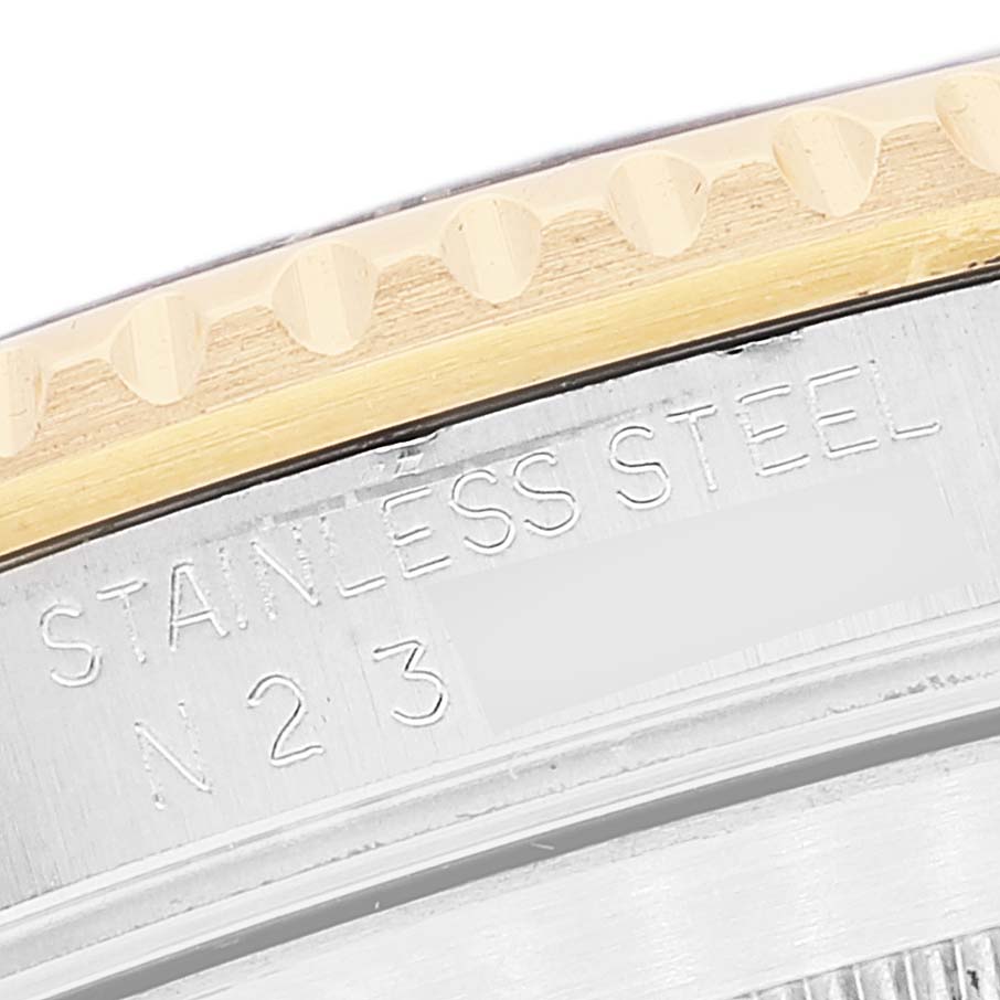 The image shows a close-up of the bezel and stainless steel case of the Rolex Submariner 16613 Men's Steel and Gold (two tone) Blue Dial.