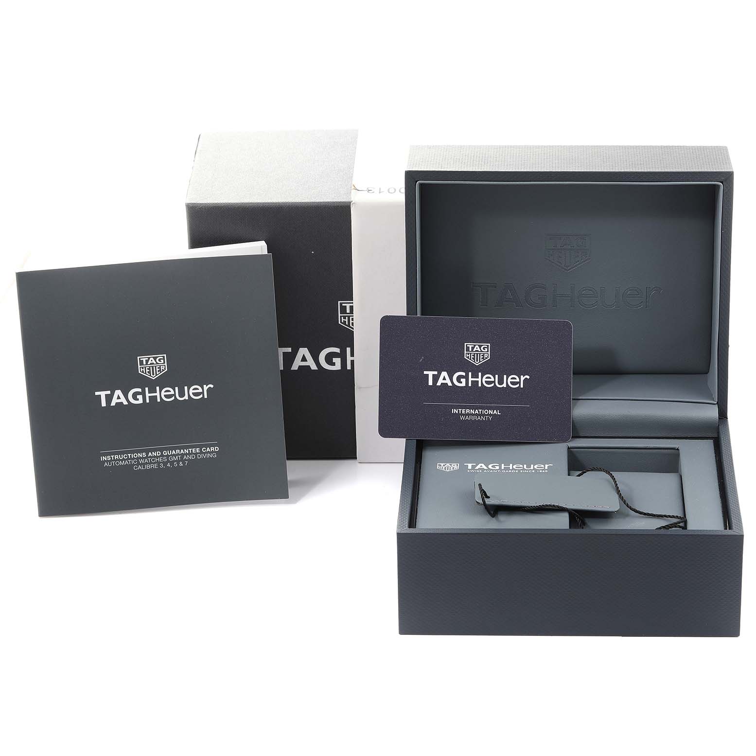 The image shows the packaging of a Tag Heuer Aquaracer WBP208B.BF0631 Men's Titanium Green Dial WBP208B.BF0631 Men's Titanium Green Dial, including the box, warranty card, and instruction manual.