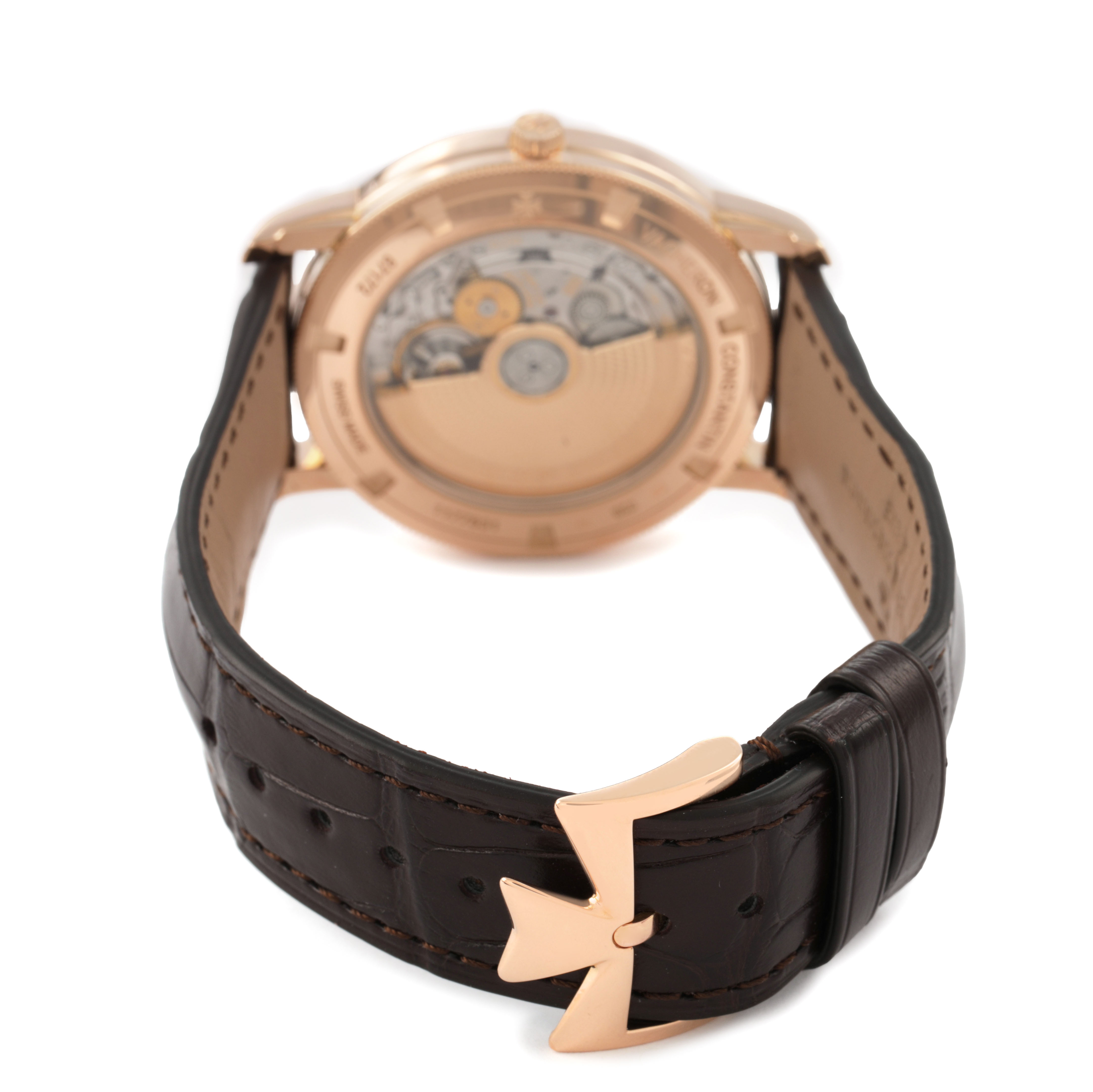 The image shows the back of the Vacheron Constantin Traditionnelle 87172/000R-9302 Men's Rose Gold Silver Dial watch, highlighting its movement and strap with a distinctive clasp.