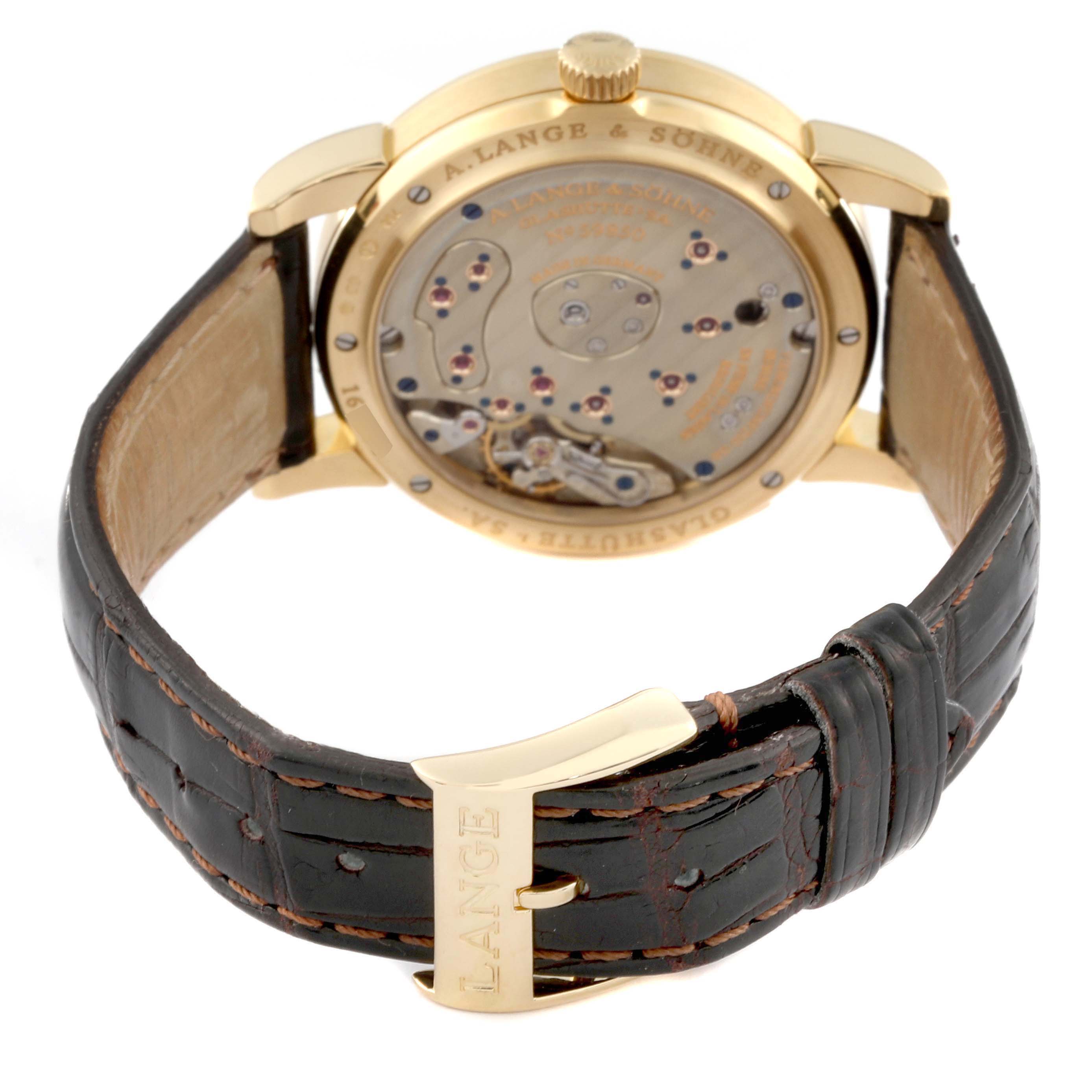 The image shows the back view of the A. Lange 
Sohne Lange 1 109.021 Men
s Yellow Gold Silver Dial watch, highlighting its movement and leather strap.