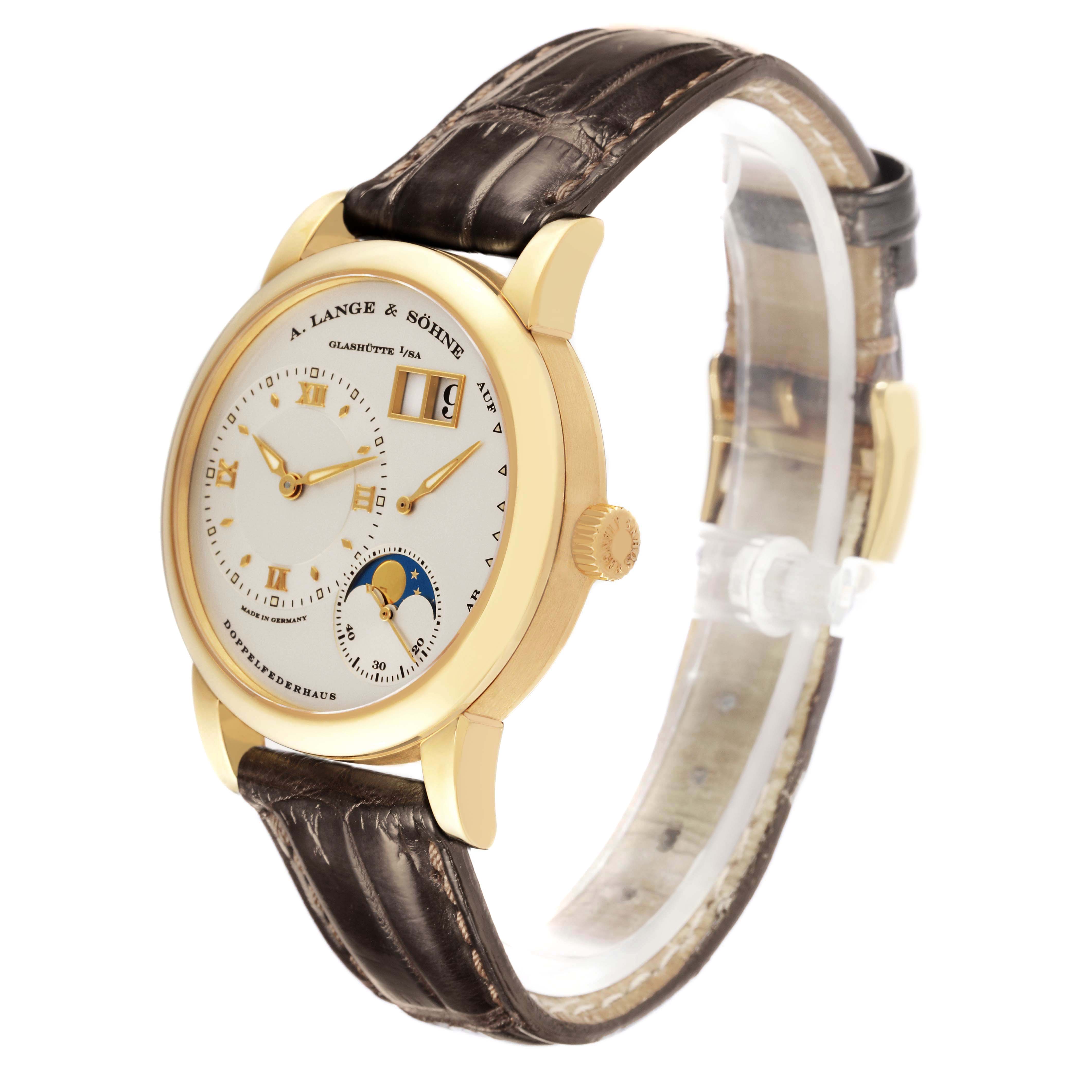 The A. Lange 
Sohne Lange 1 109.021 Men
s Yellow Gold Silver Dial watch is shown at a slight angle, highlighting the case, dial, strap, and side crown.