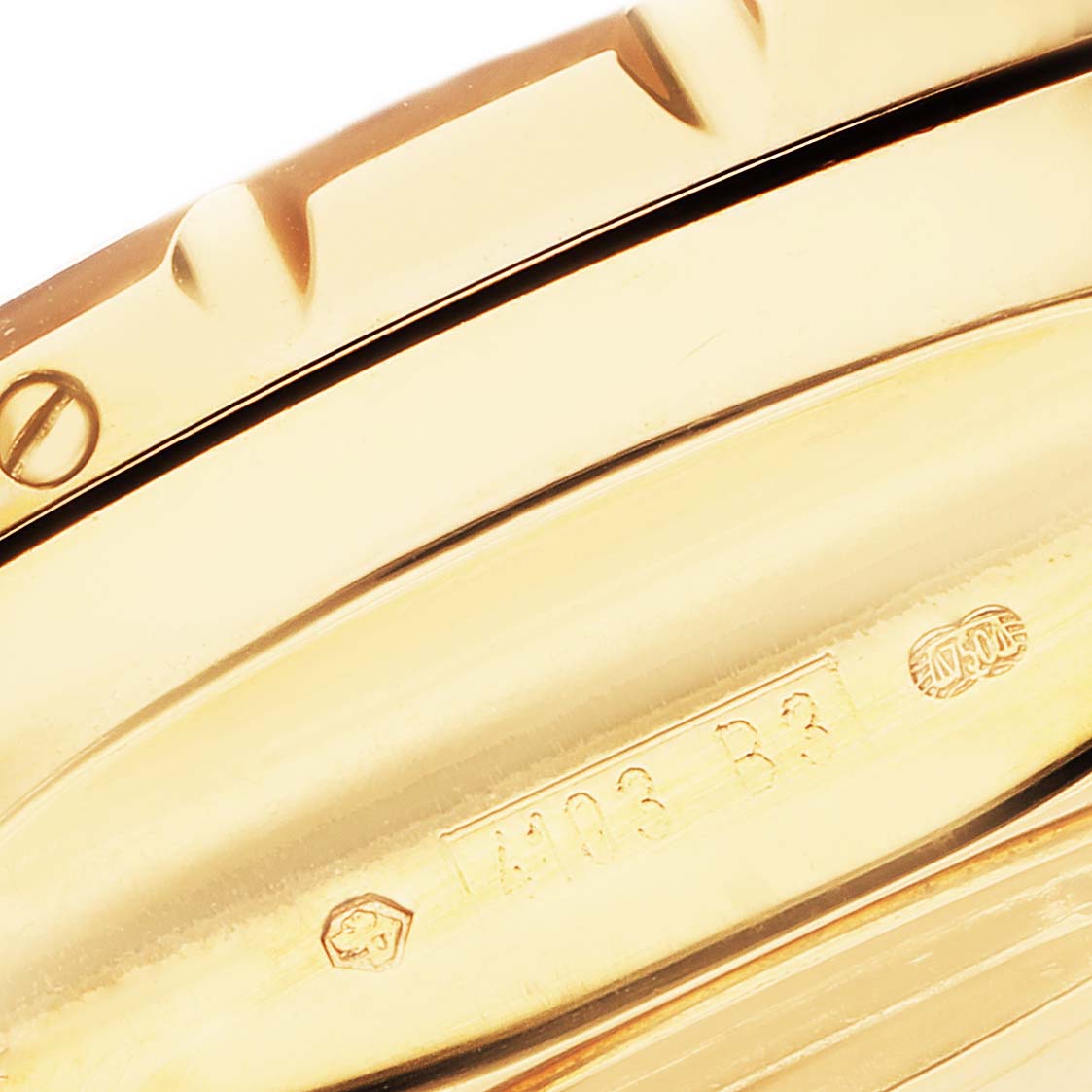 The image shows a close-up of the side of the gold bezel and case with engravings on a Bentley model by Breitling watch.
