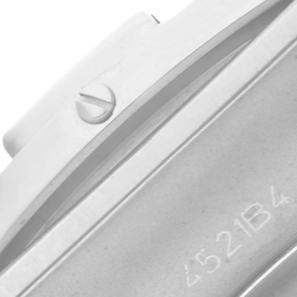 The image shows a close-up angle of a screw and serial number on the casing of a Breitling Chronomat AB0134 Men
s Stainless Steel Silver Dial AB0134 Men
s Stainless Steel Silver Dial watch.