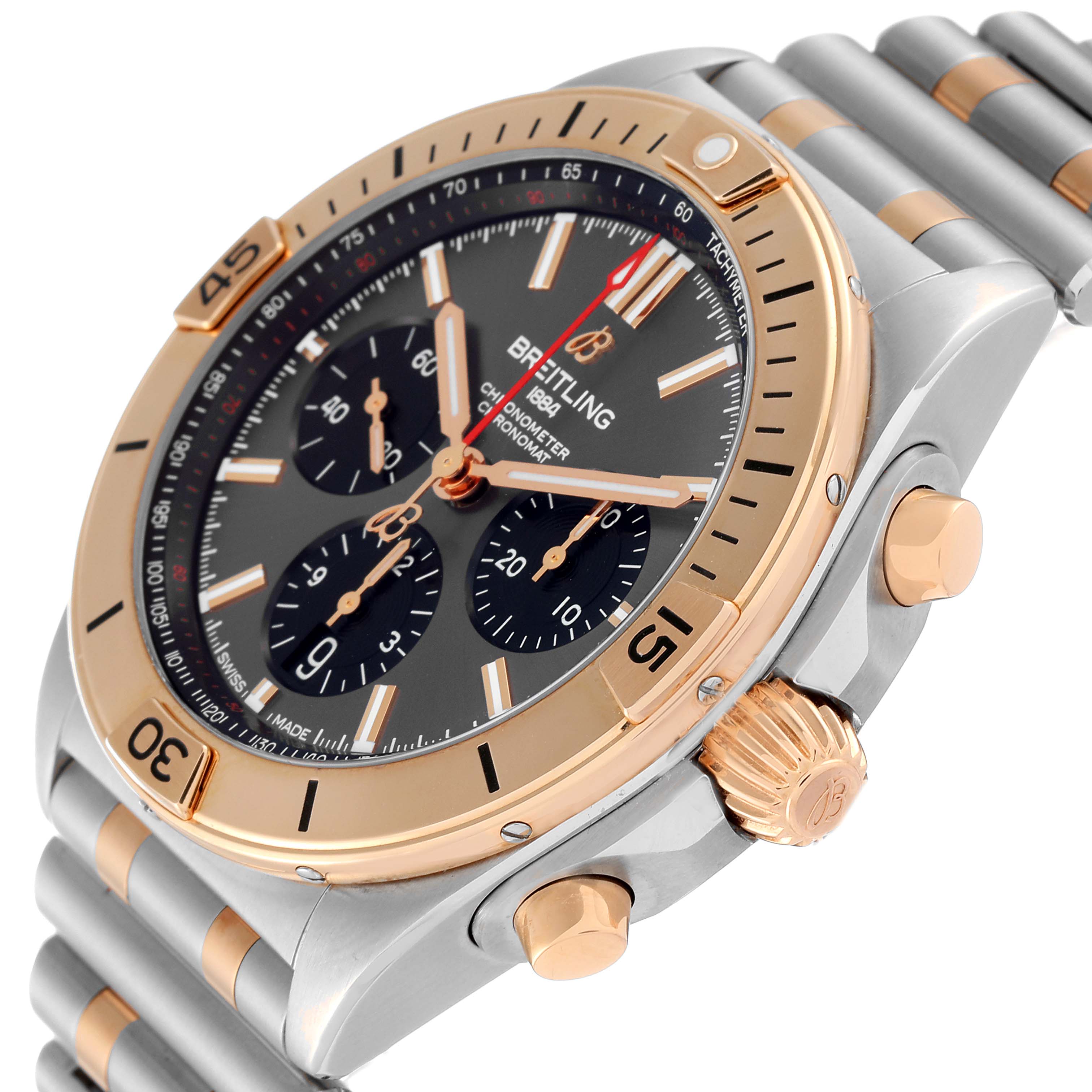 The Breitling Chronomat UB0134 Men's Steel and Gold (two tone) Grey Dial UB0134 Men's Steel and Gold (two tone) Grey Dial watch is shown at a side angle, highlighting its bezel, crown, push buttons, and stainless-steel bracelet.