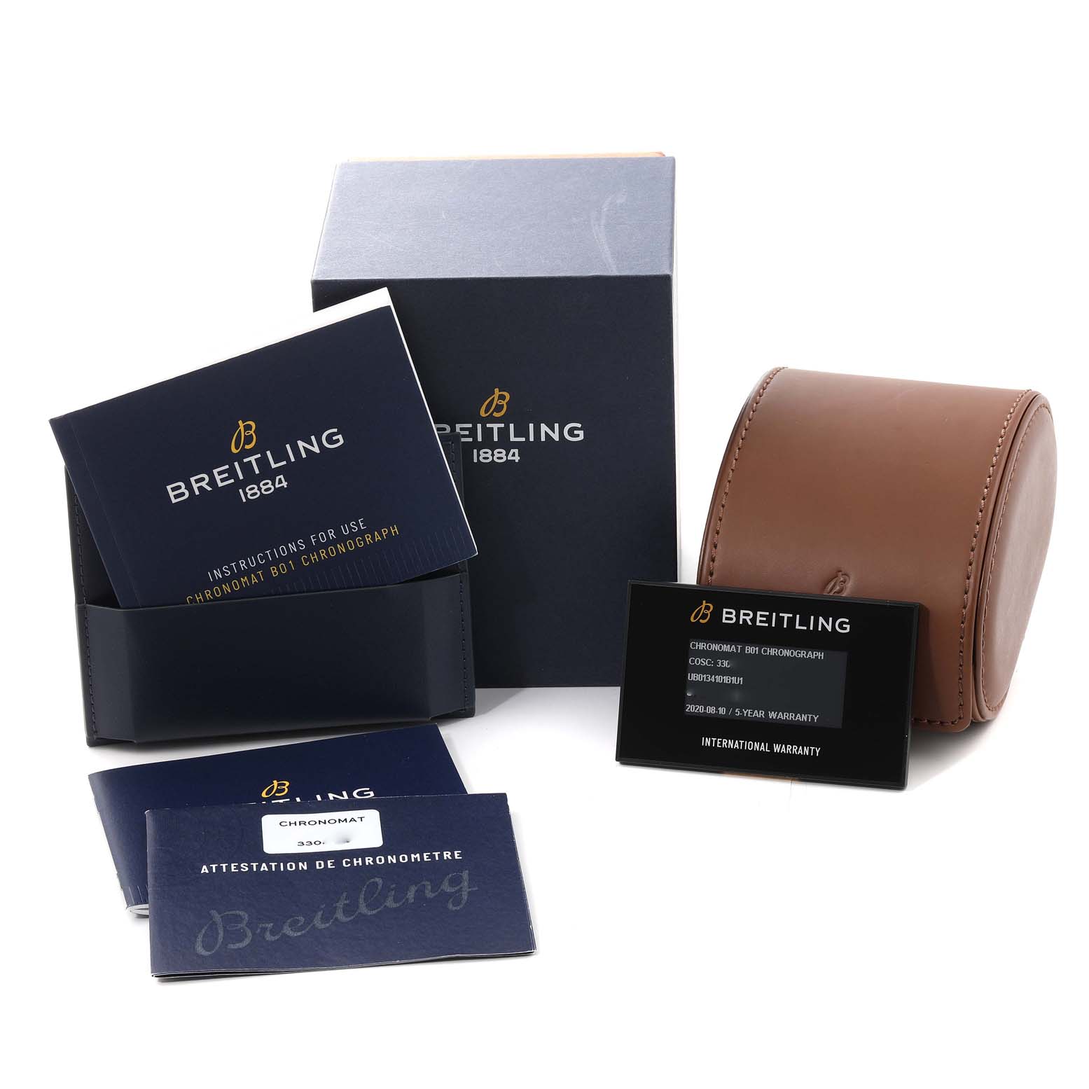 The image shows accessories for the Breitling Chronomat UB0134 Men's Steel and Gold (two tone) Grey Dial UB0134 Men's Steel and Gold (two tone) Grey Dial model, including manuals, warranty cards, a box, and a storage case.
