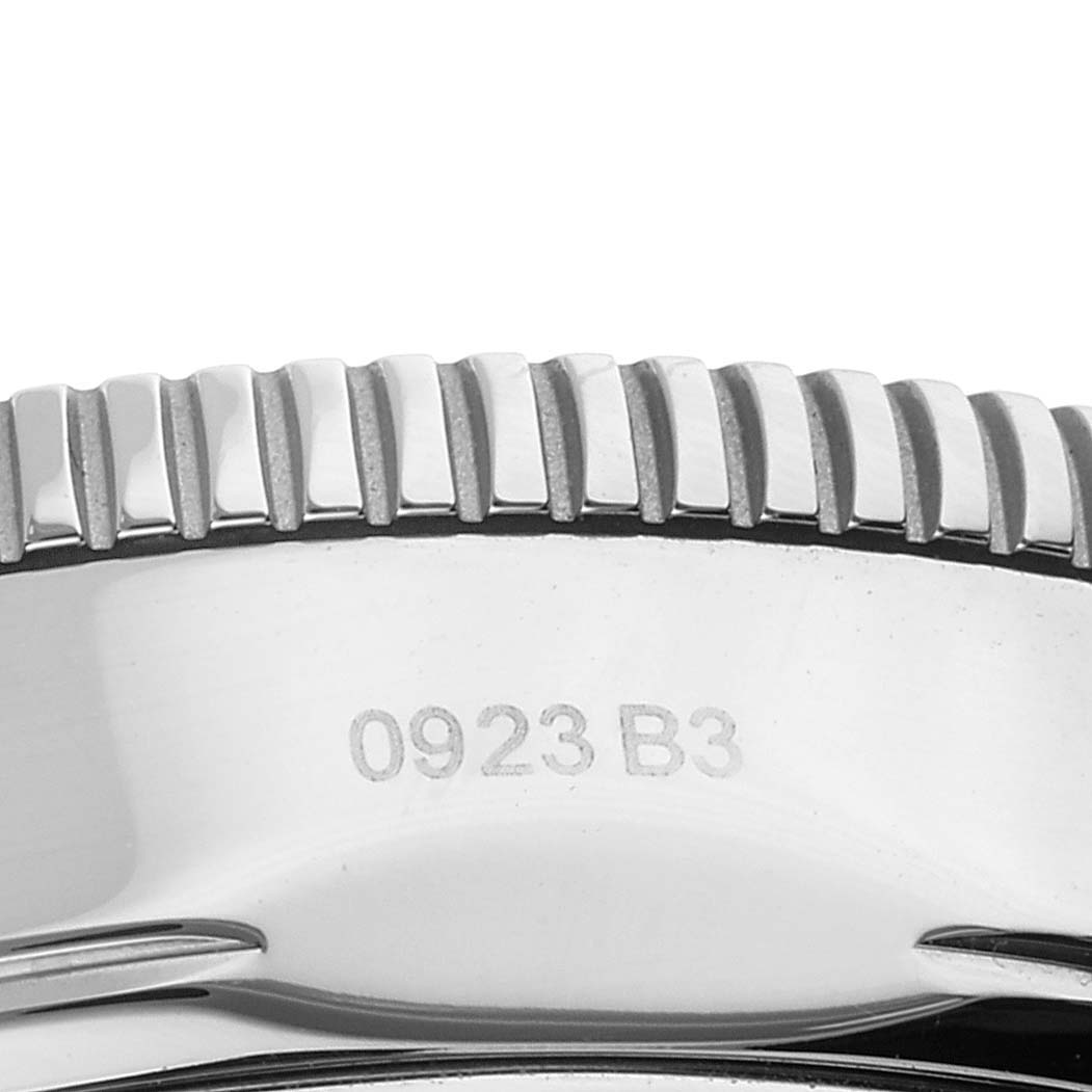 This image shows a close-up of the bezel and a portion of the case back with markings on a Breitling Superocean AB20108A1C1S1 Men's Stainless Steel Blue Dial AB20108A1C1S1 Men's Stainless Steel Blue Dial watch.