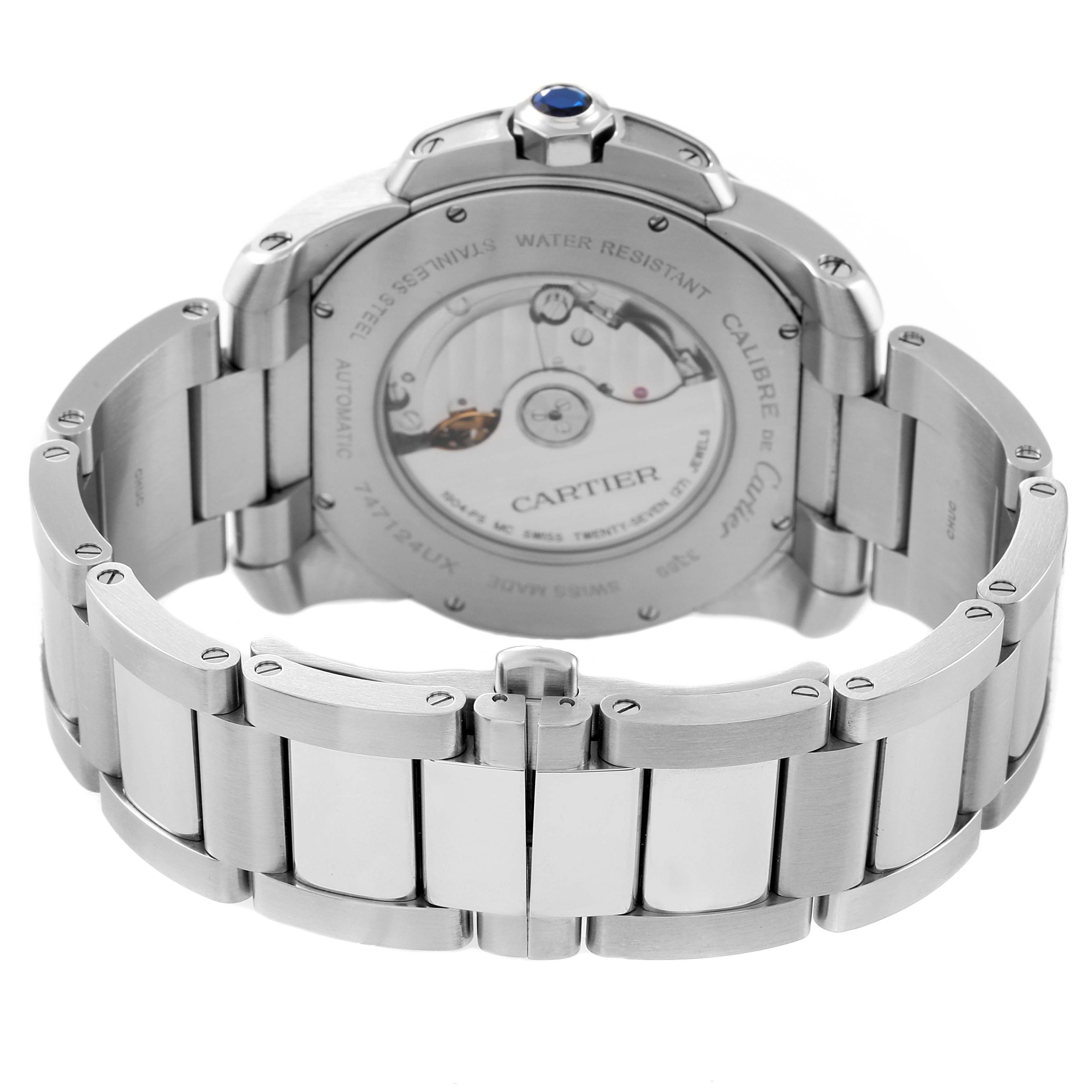 The image shows the back view of a Calibre de Cartier watch by Cartier, highlighting its stainless steel case and visible automatic movement.