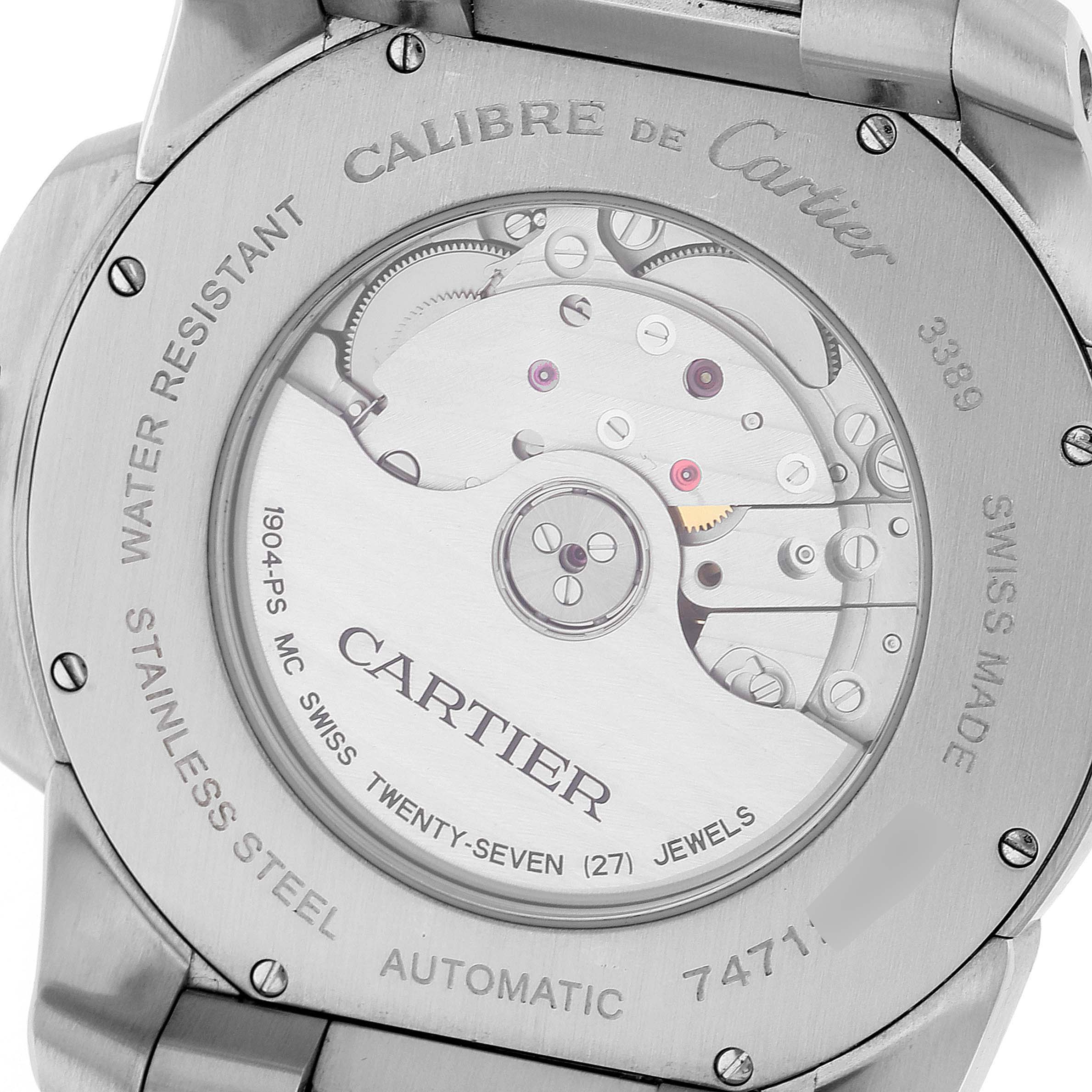 The image shows the back case of the Calibre de Cartier watch, highlighting its automatic movement and internal mechanics.