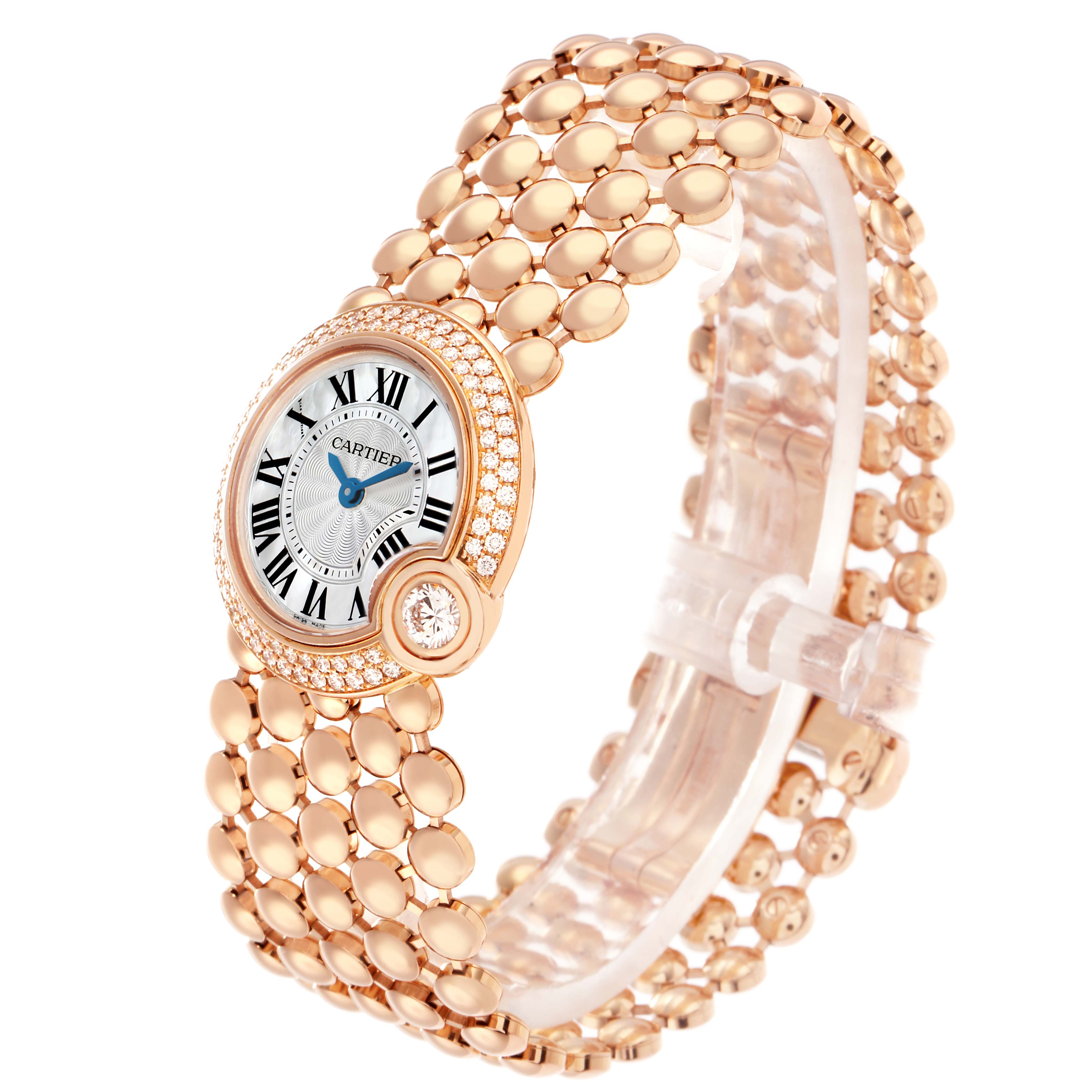 The Cartier Ballon Blanc WE902057 Women
s Rose Gold Mother of Pearl Dial watch is shown at a three-quarter angle, highlighting its dial, diamond bezel, and linked bracelet.