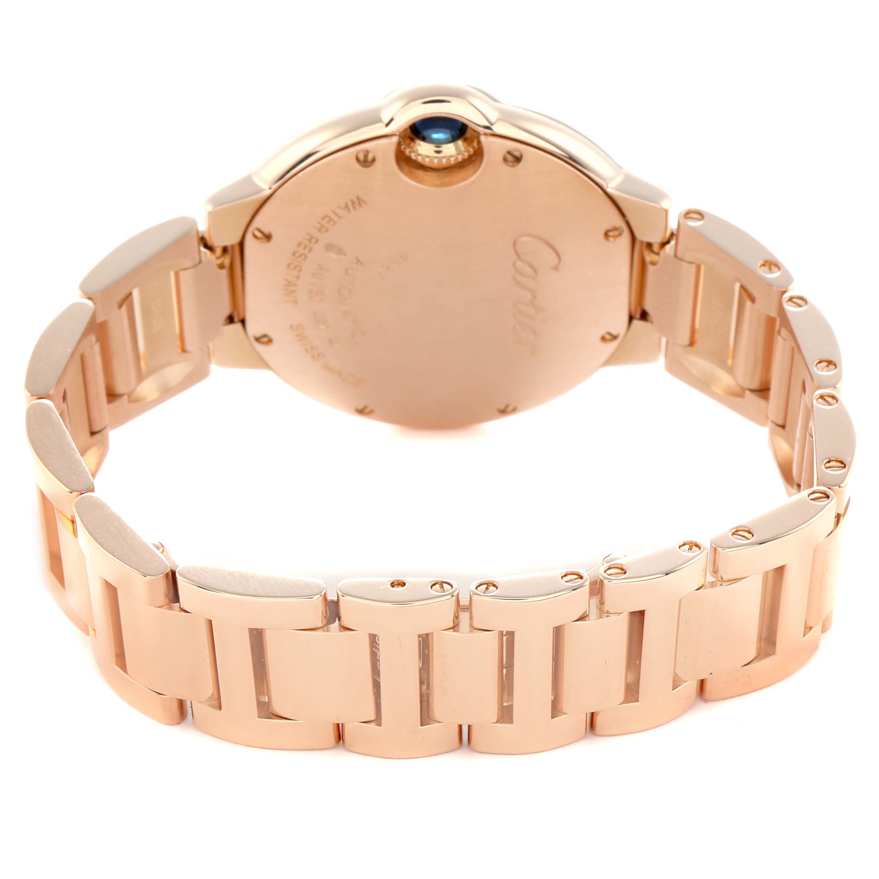 The image shows the back case and bracelet of a Cartier Ballon Bleu W6920096 Women
s Rose Gold Silver Dial watch at an angle highlighting its clasp and crown.