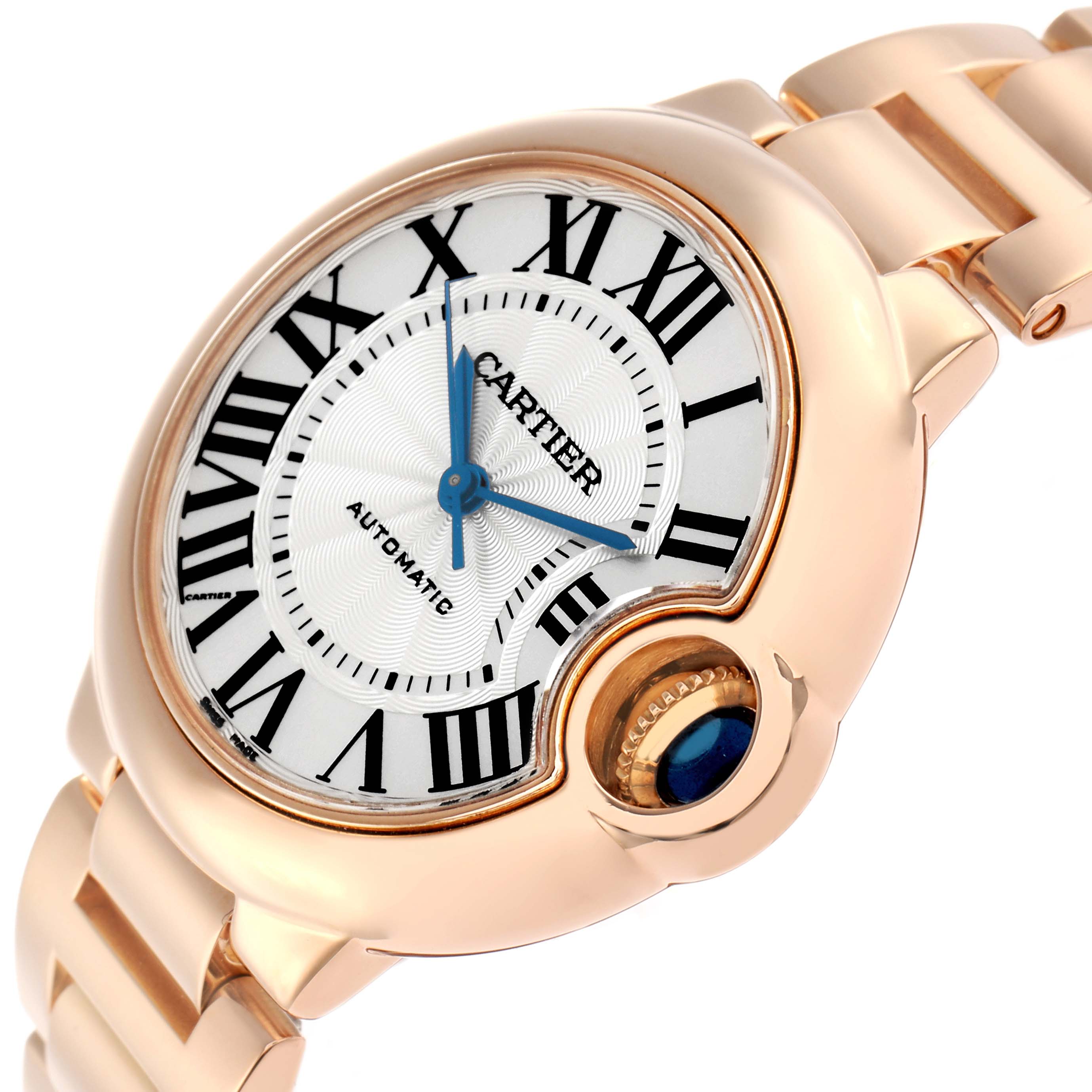 The Cartier Ballon Bleu W6920096 Women
s Rose Gold Silver Dial watch is shown at a slight angle, highlighting the dial, blue hands, Roman numerals, and crown with a blue cabochon.